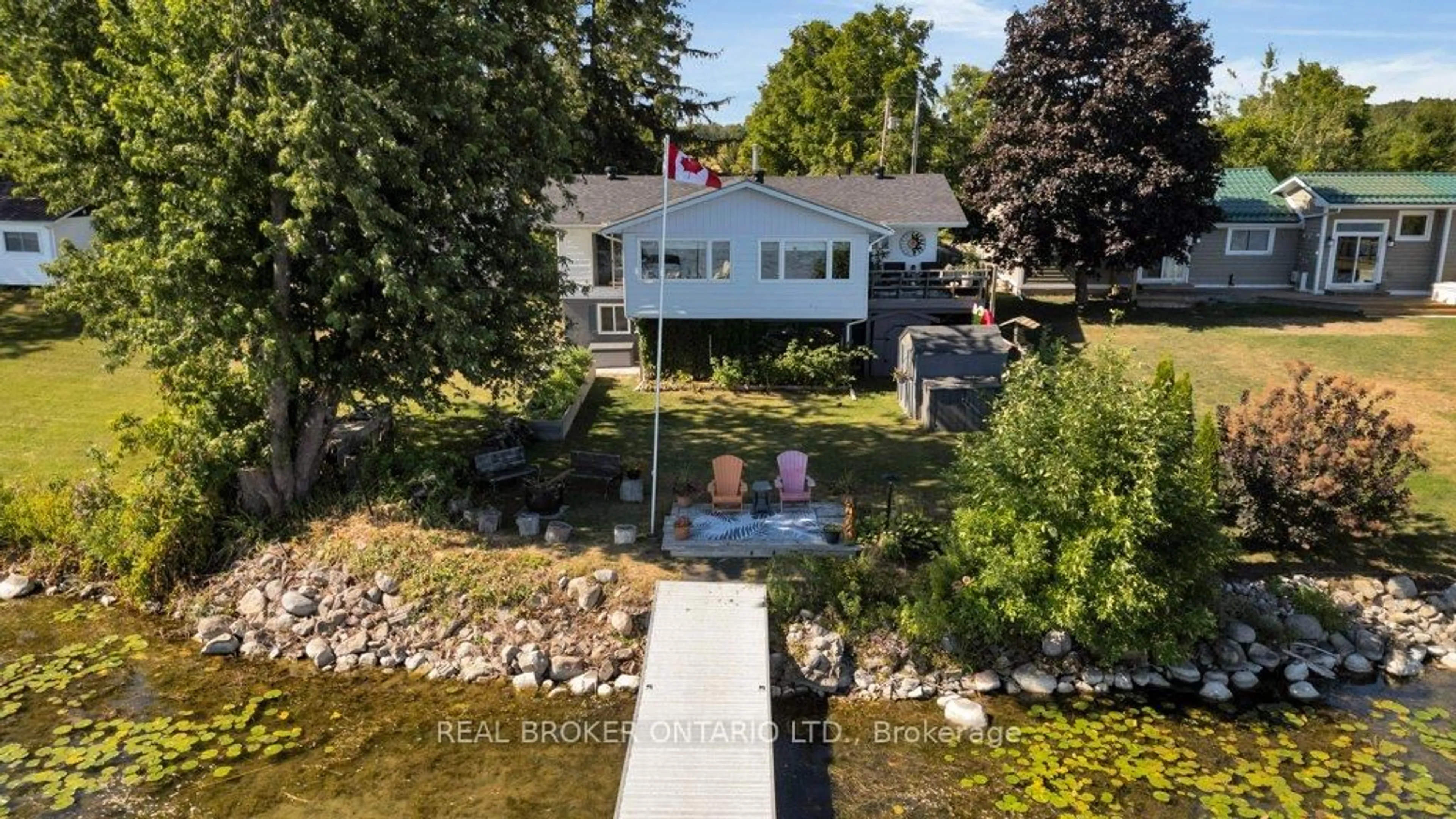 A pic from outside/outdoor area/front of a property/back of a property/a pic from drone, street for 1909 Woods Bay Rd, Severn Ontario L3V 0V7