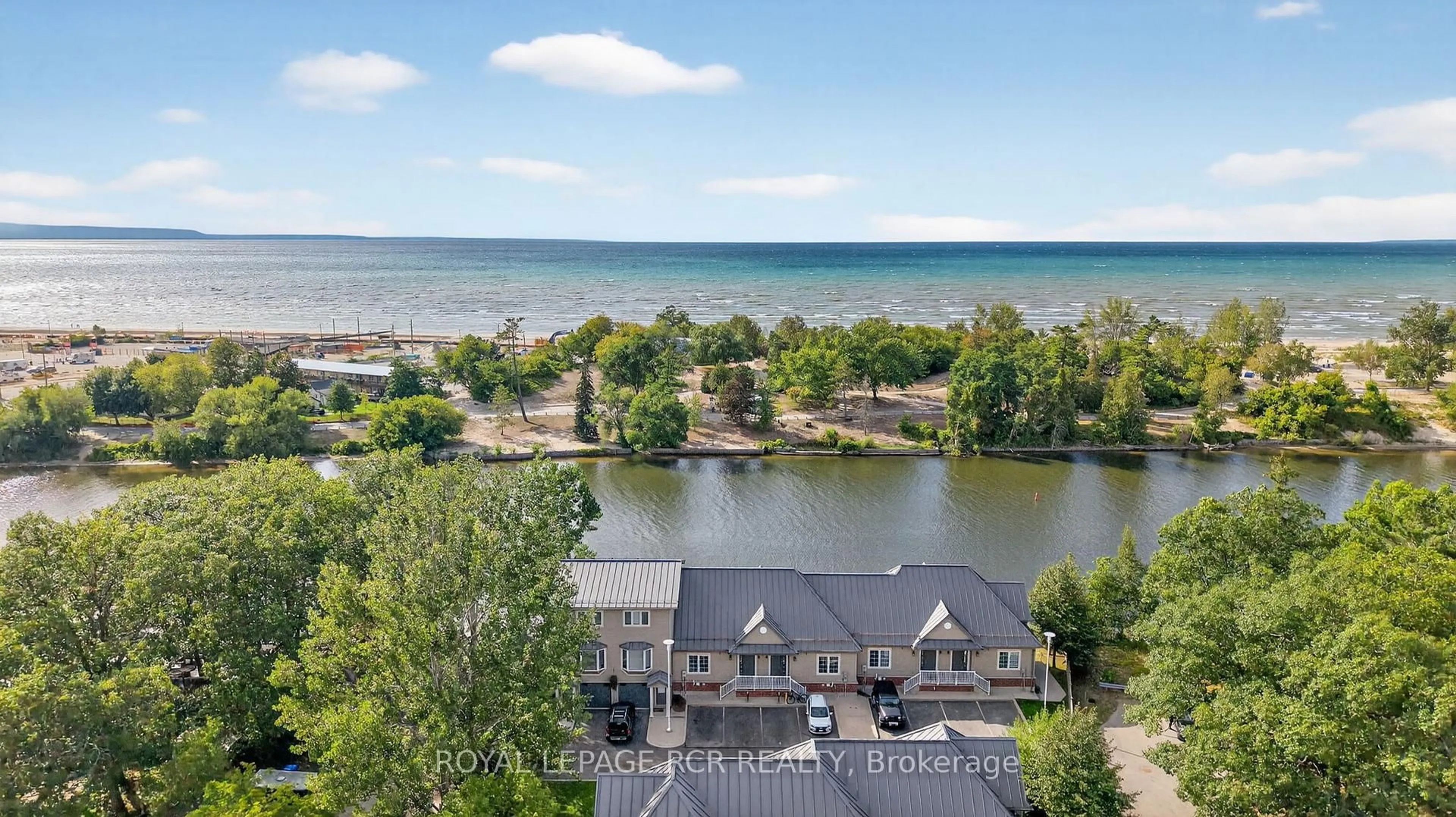 A pic from outside/outdoor area/front of a property/back of a property/a pic from drone, water/lake/river/ocean view for 64 River Rd #3, Wasaga Beach Ontario L9Z 2L1