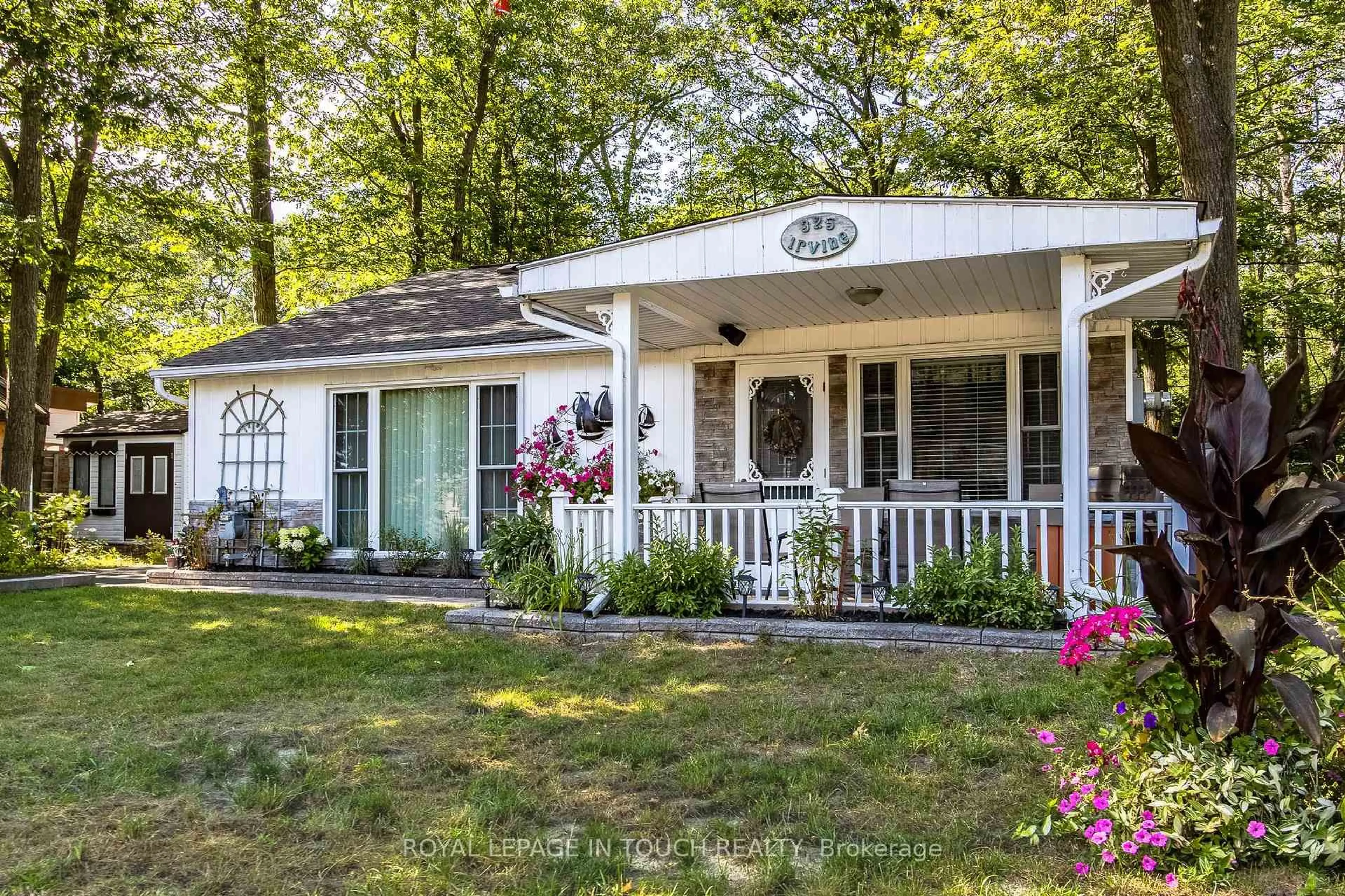 Home with vinyl exterior material, street for 325 Tiny Beaches Rd, Tiny Ontario L0L 2J0