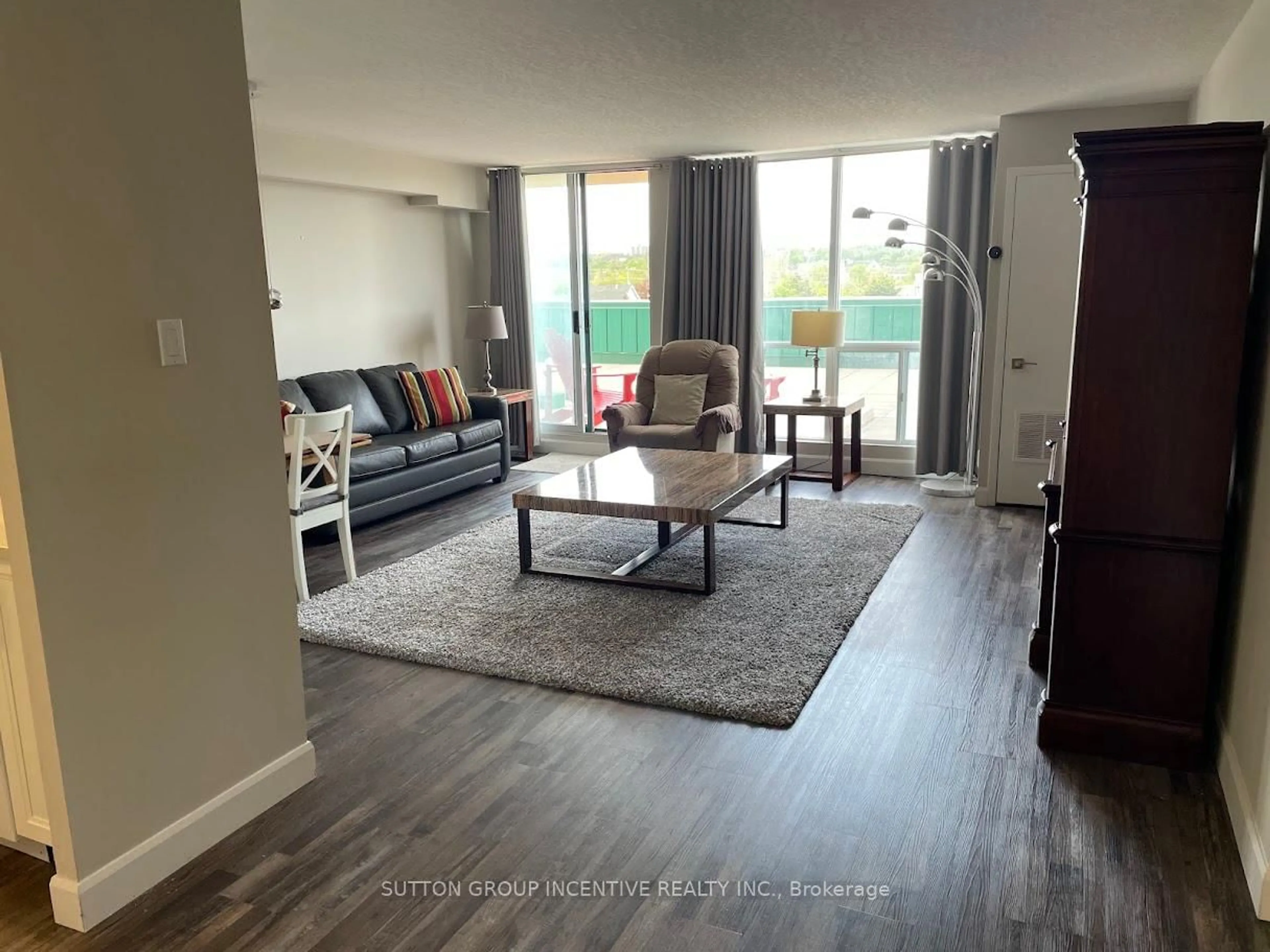 Living room with furniture, wood/laminate floor for 65 Ellen St #111, Barrie Ontario L4N 3A5