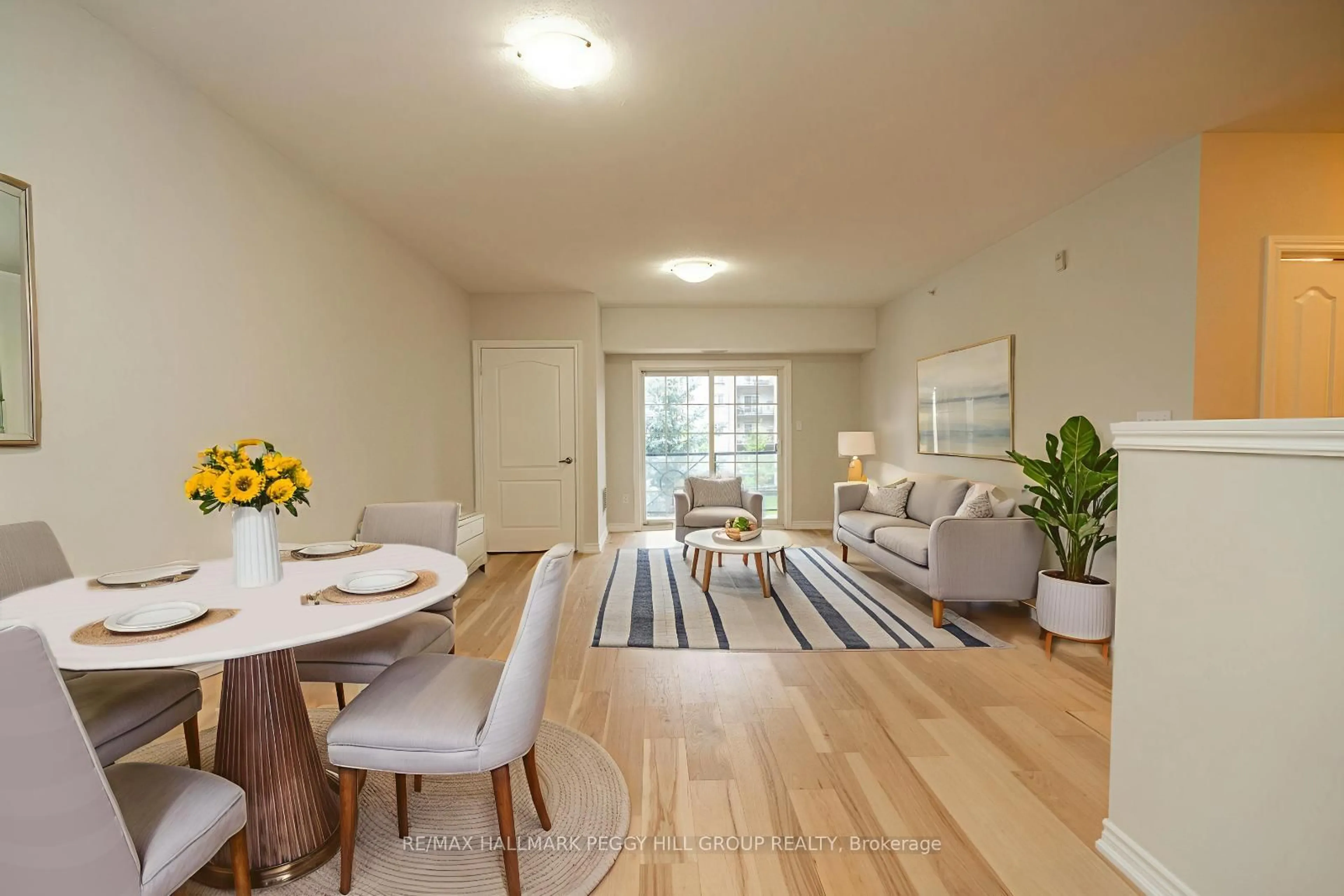 Living room with furniture, wood/laminate floor for 39 Ferndale Dr #205, Barrie Ontario L4N 5T5