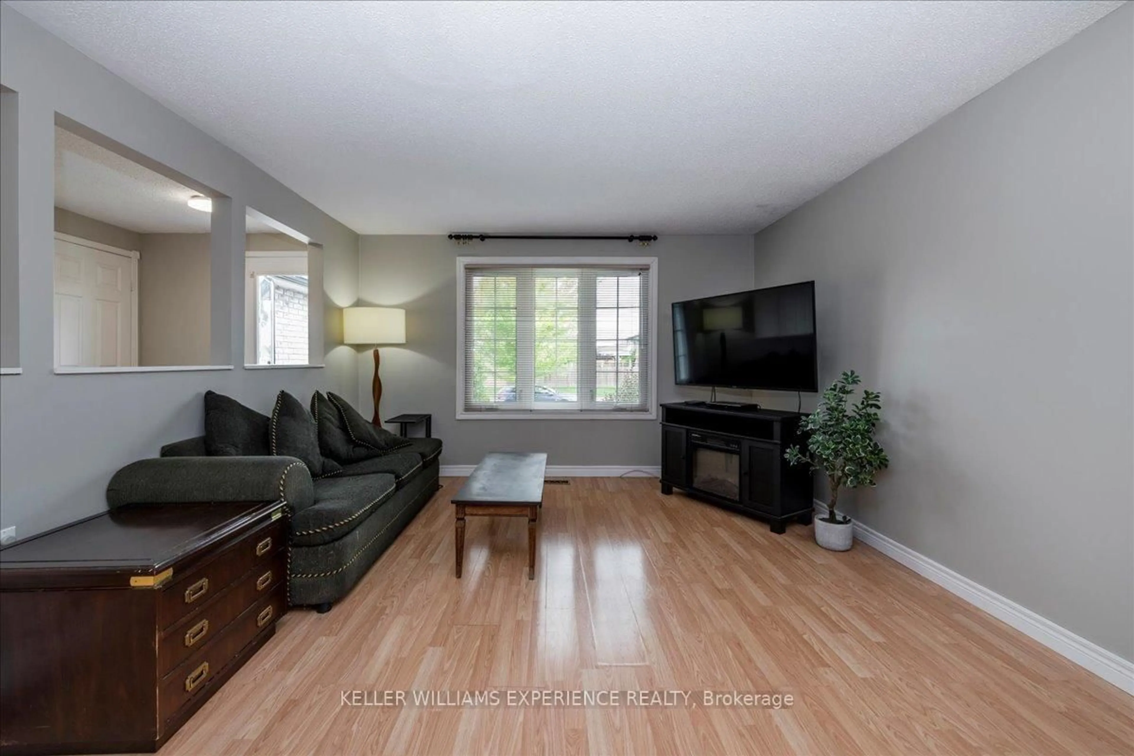 Living room with furniture, wood/laminate floor for 57 Gloria St, Barrie Ontario L4N 5W5
