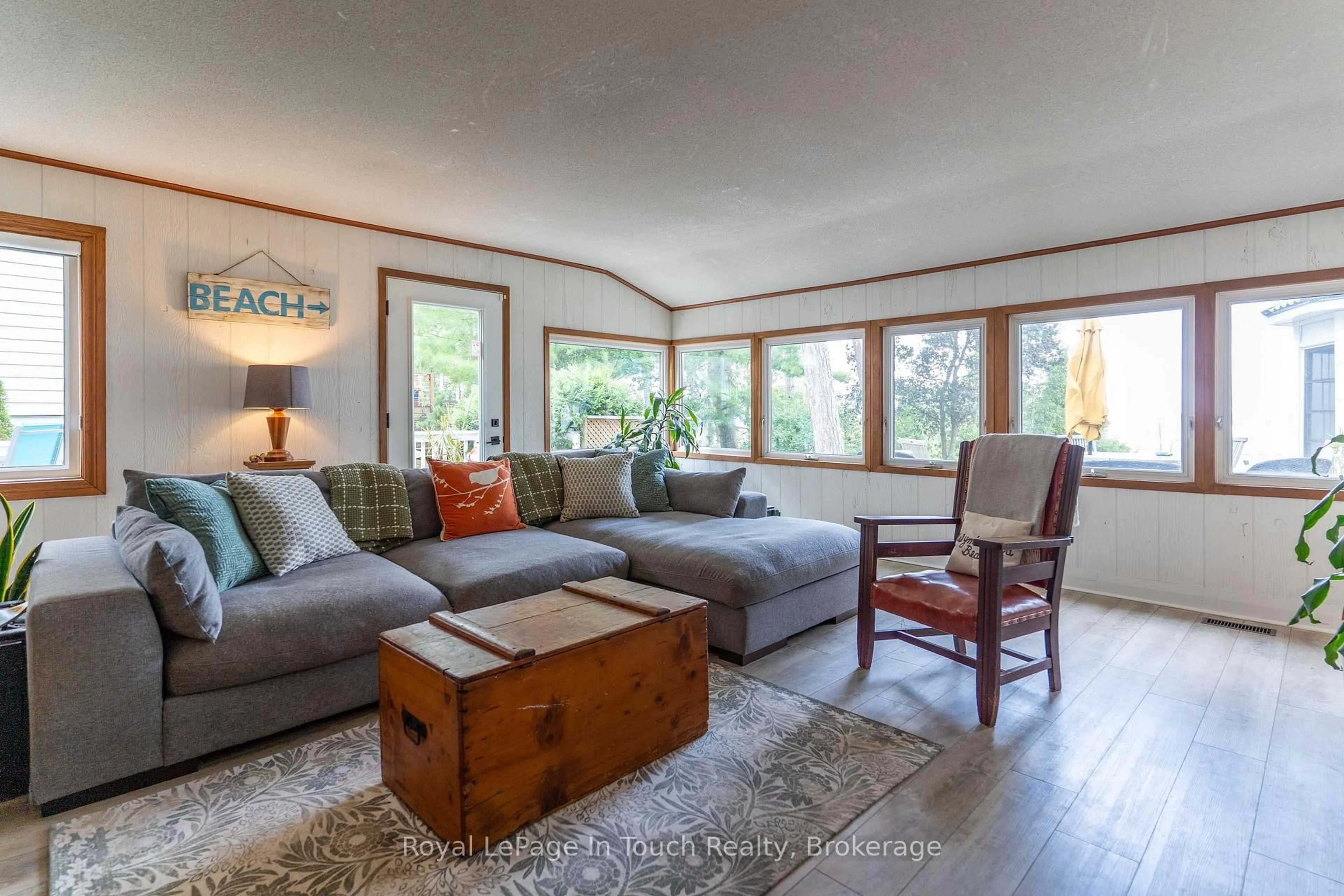 Living room with furniture, wood/laminate floor for 434 Tiny Beaches Rd, Tiny Ontario L0L 2T0