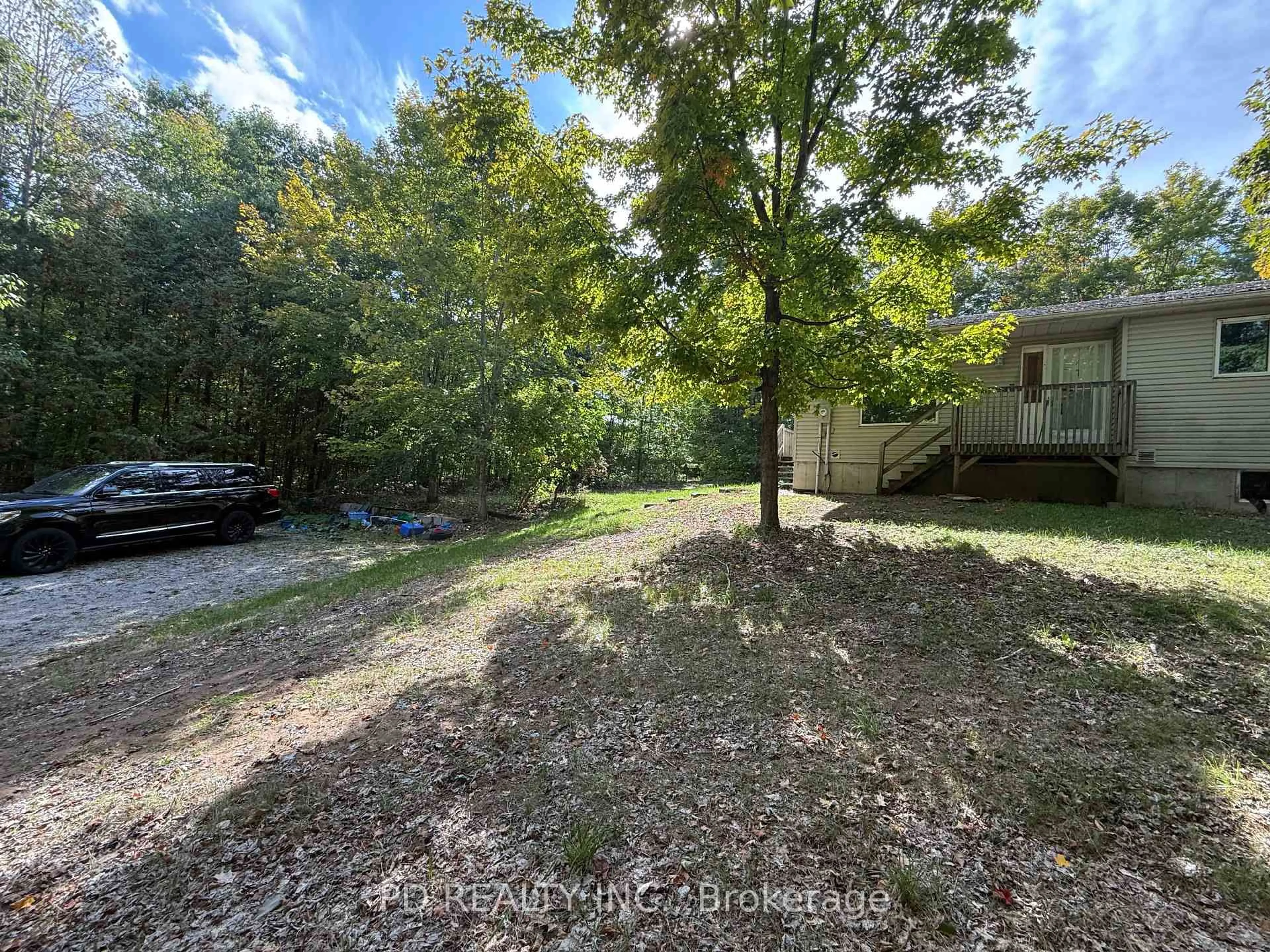 A pic from outside/outdoor area/front of a property/back of a property/a pic from drone, forest/trees view for 5840 Lowanda Lane, Ramara Ontario L0K 1W0