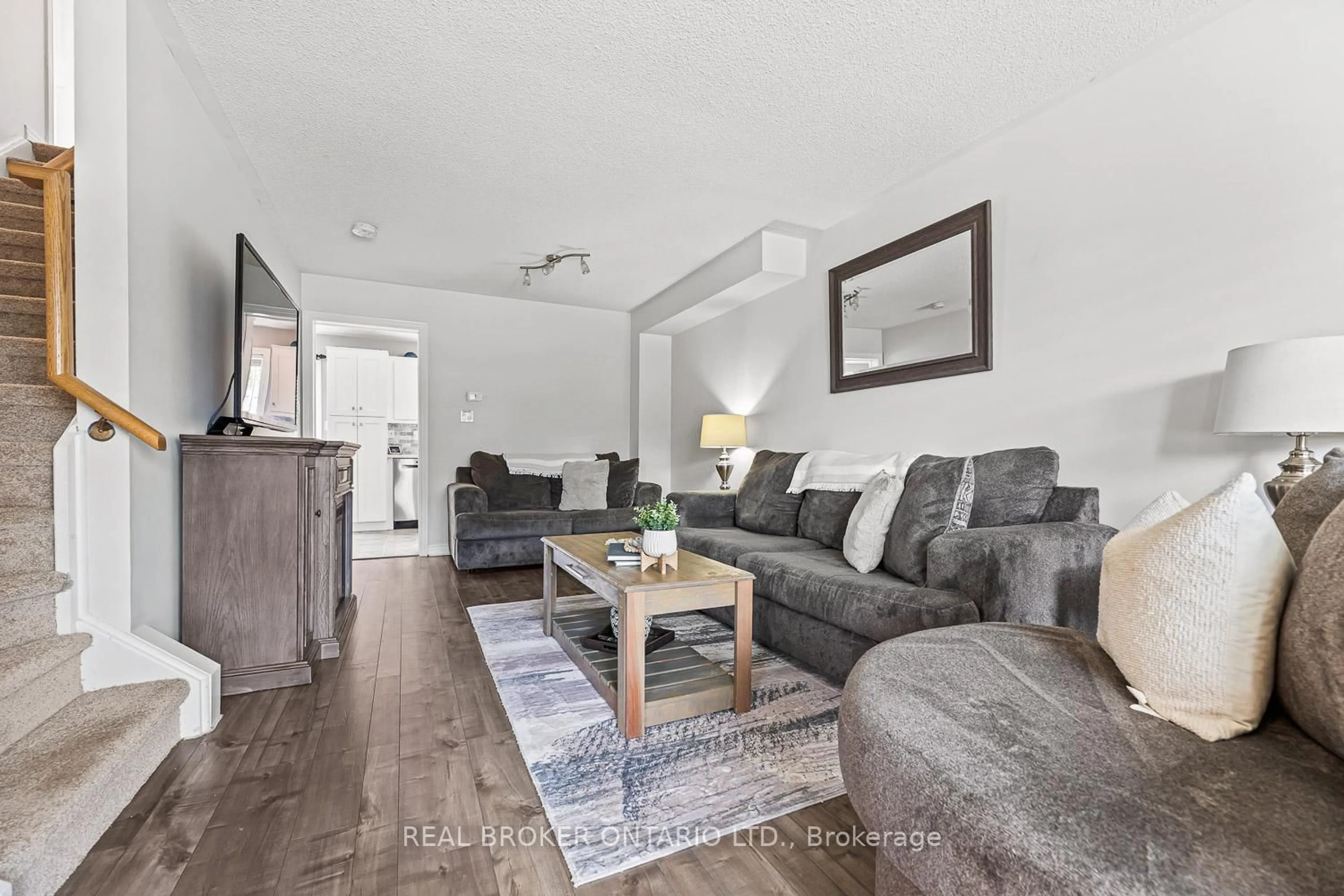 Living room with furniture, wood/laminate floor for 89 Bentley Cres, Barrie Ontario L4N 0Z1