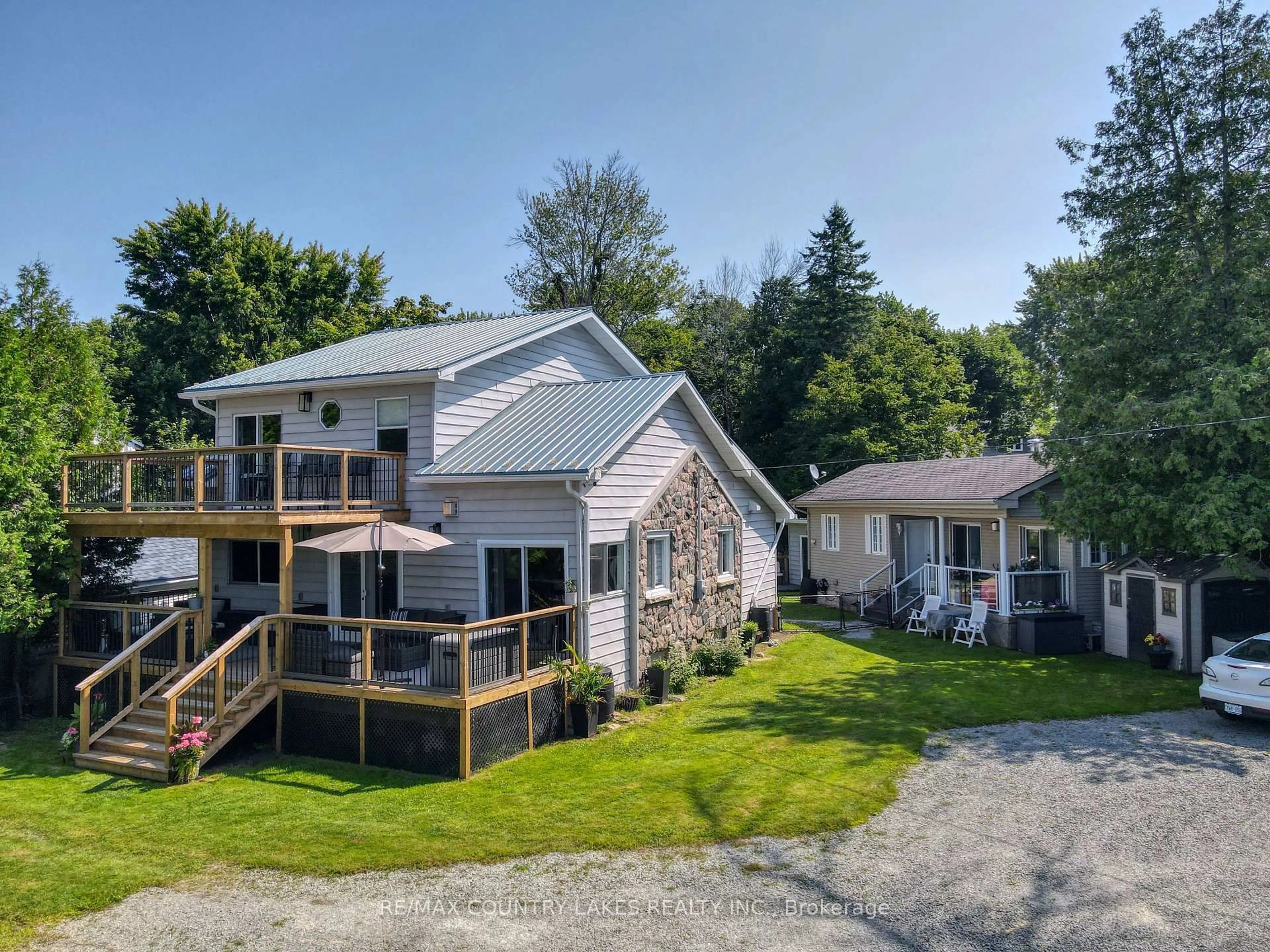 A pic from outside/outdoor area/front of a property/back of a property/a pic from drone, water/lake/river/ocean view for 104 The Steps Rd, Ramara Ontario L0K 1B0