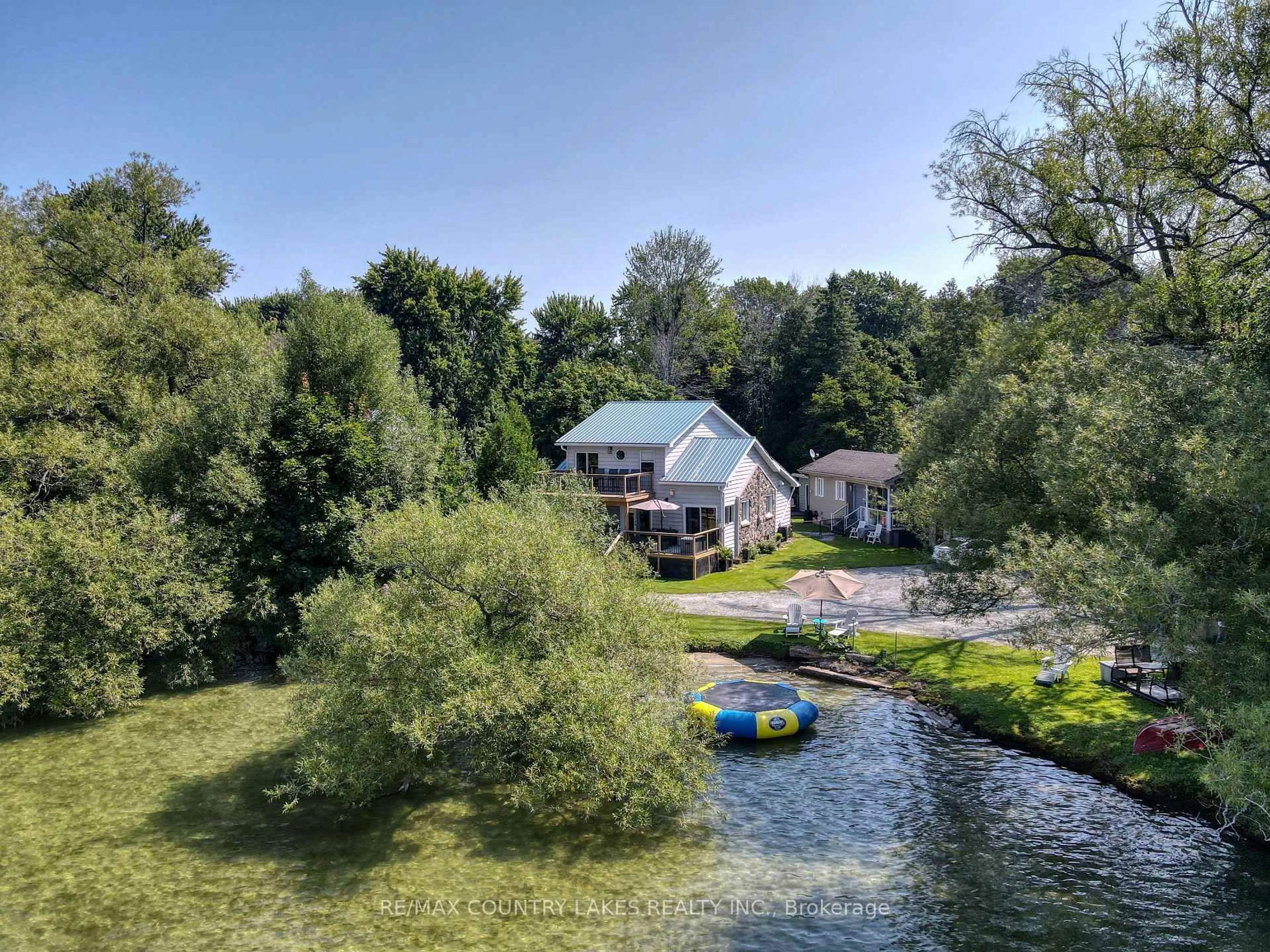 A pic from outside/outdoor area/front of a property/back of a property/a pic from drone, water/lake/river/ocean view for 104 The Steps Rd, Ramara Ontario L0K 1B0