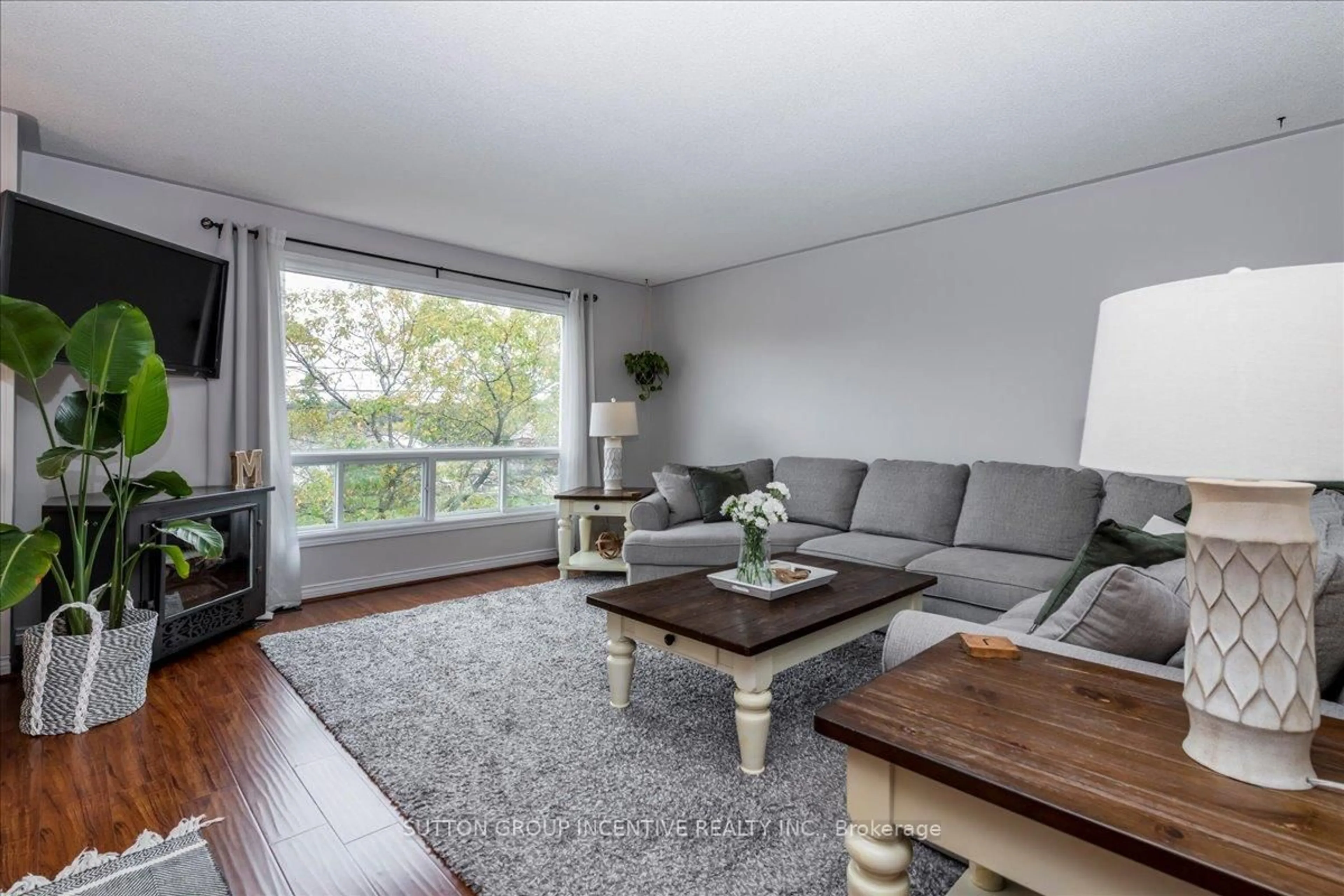 Living room with furniture, wood/laminate floor for 222 Huronia Rd, Barrie Ontario L4N 8A7