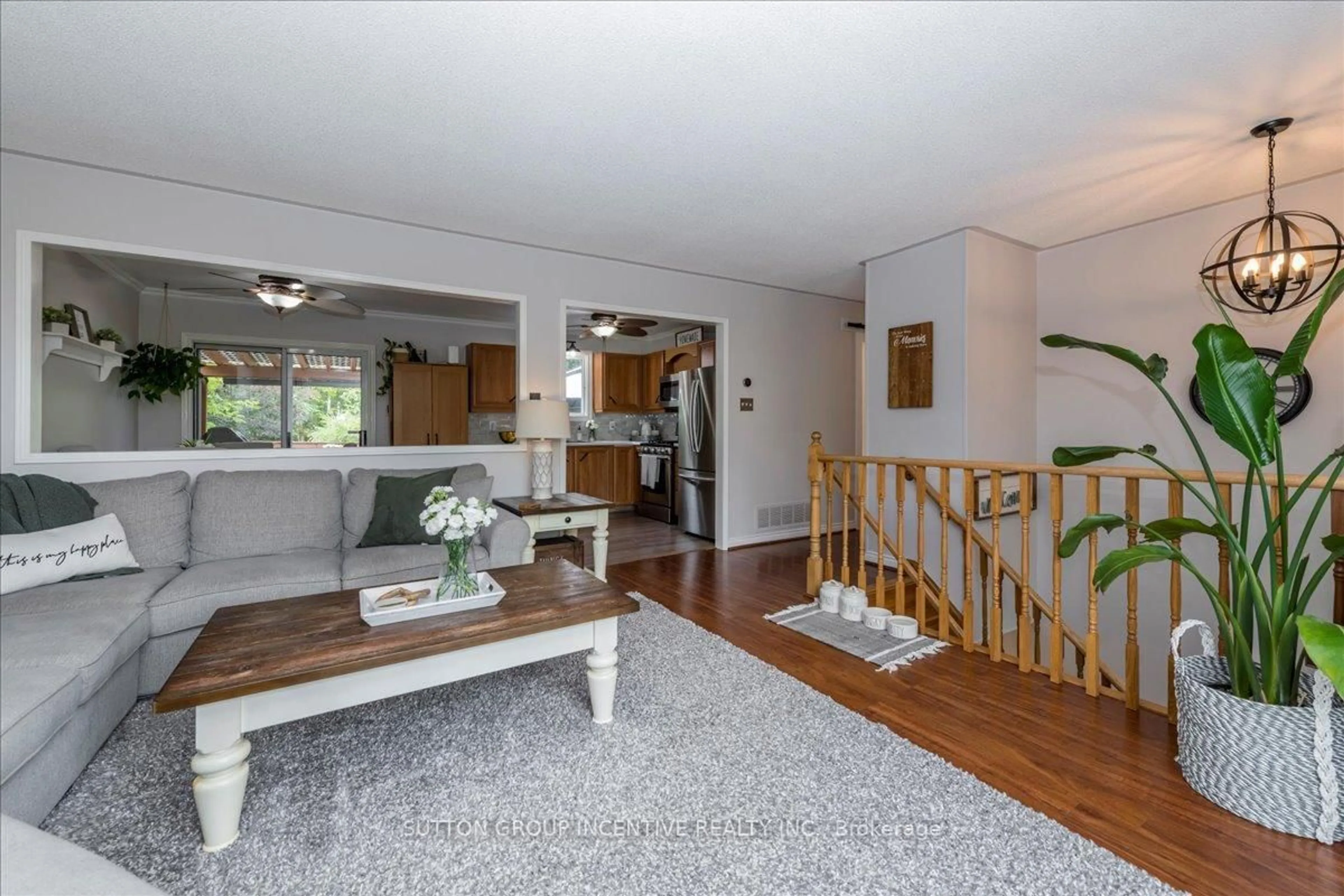 Living room with furniture, wood/laminate floor for 222 Huronia Rd, Barrie Ontario L4N 8A7