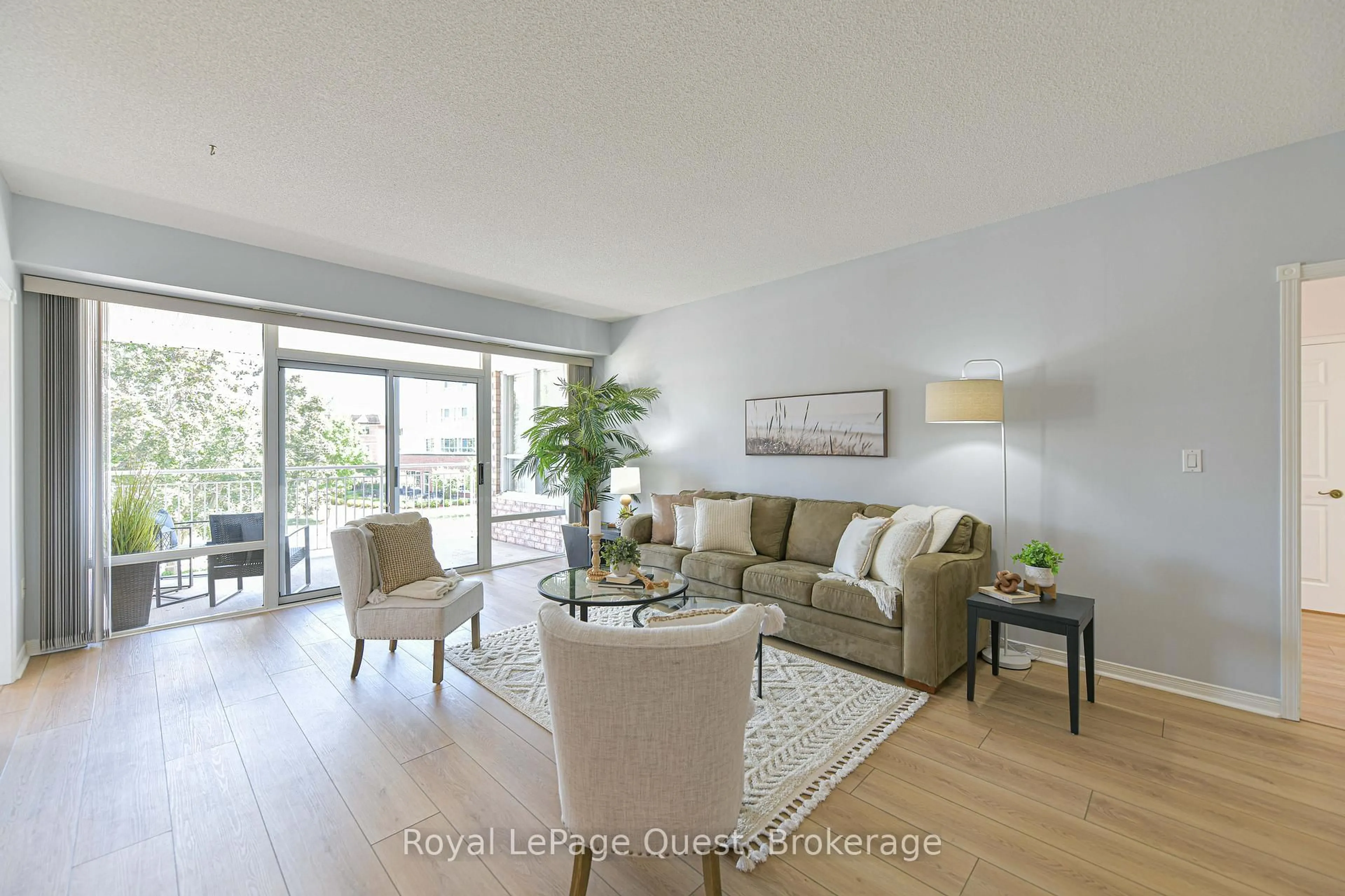 Living room with furniture, wood/laminate floor for 20 Museum Dr #208, Orillia Ontario L3V 7T9