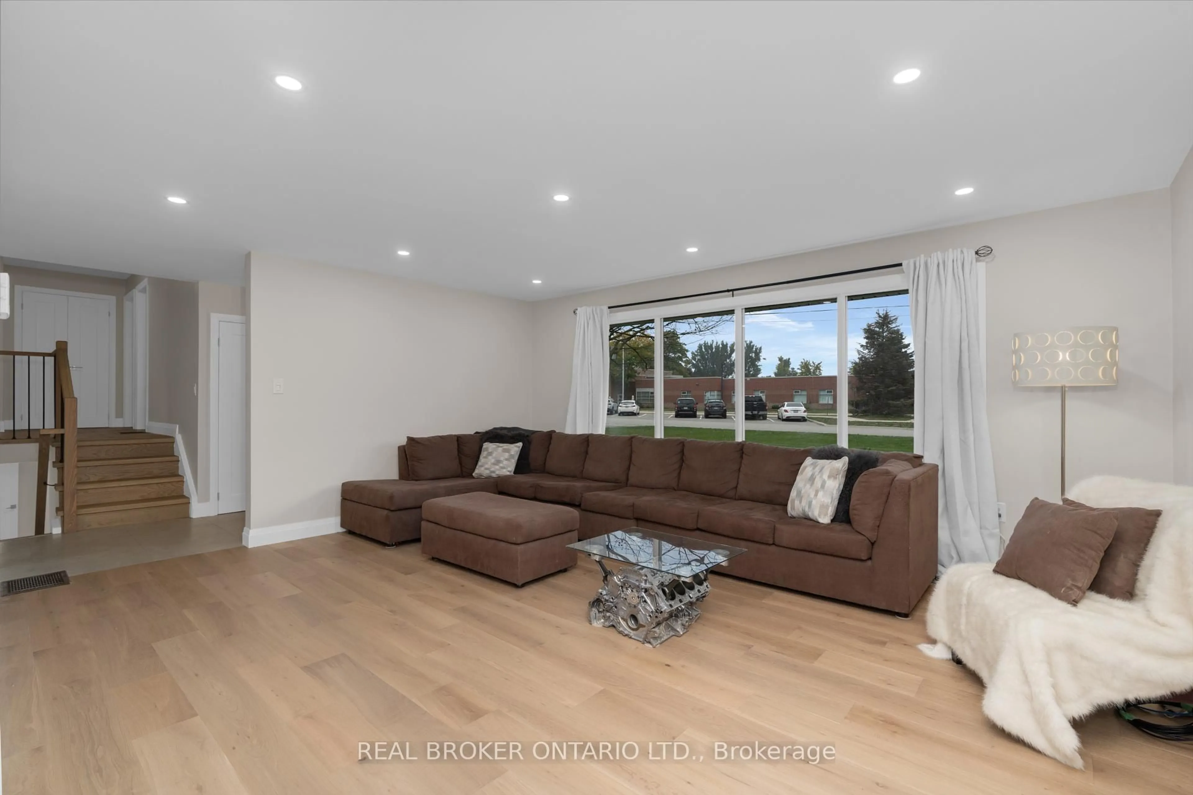 Living room with furniture, wood/laminate floor for 17 Locke Ave, Clearview Ontario L0M 1S0