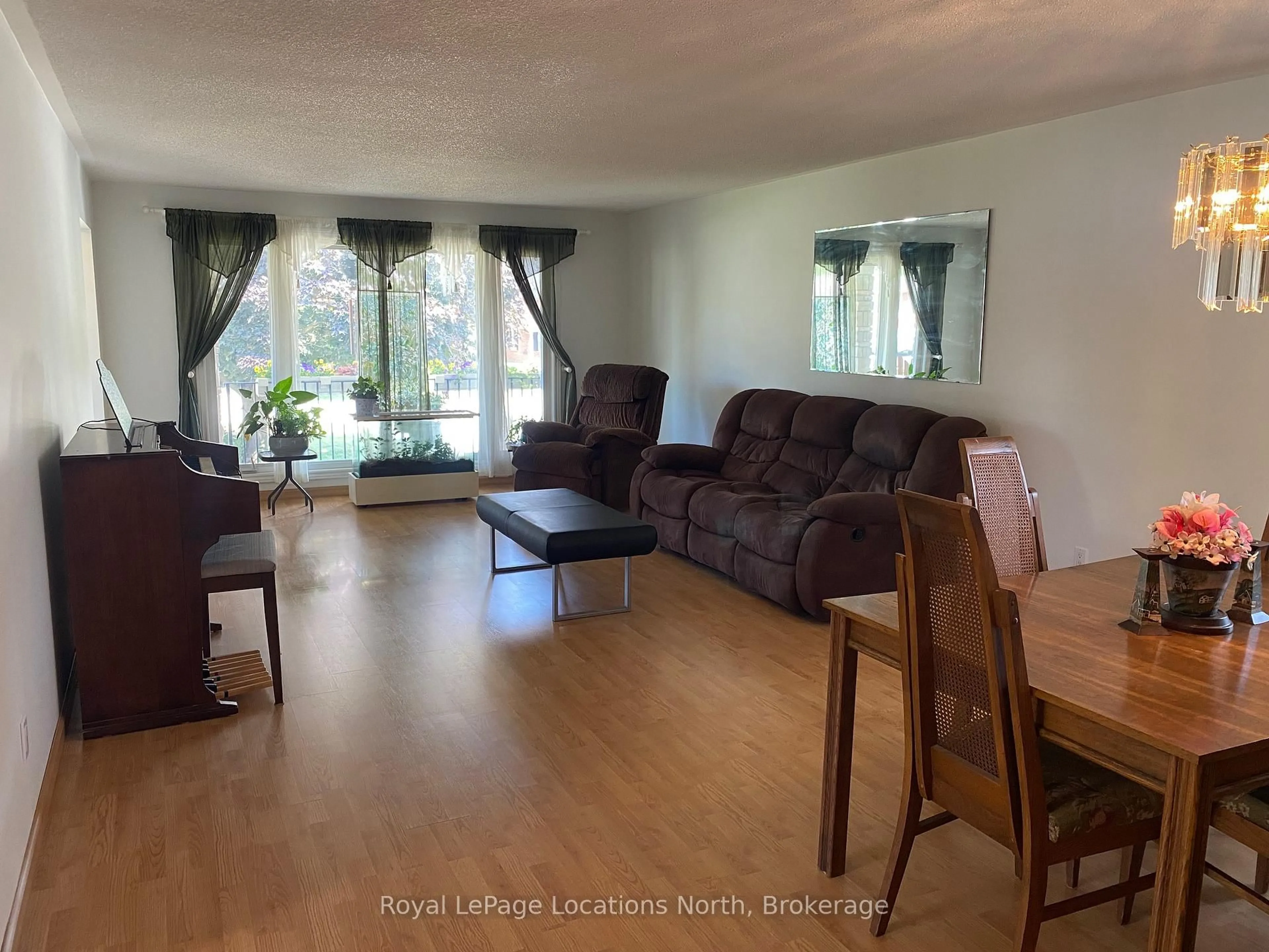 Living room with furniture, wood/laminate floor for 221 John St, Clearview Ontario L0M 1S0