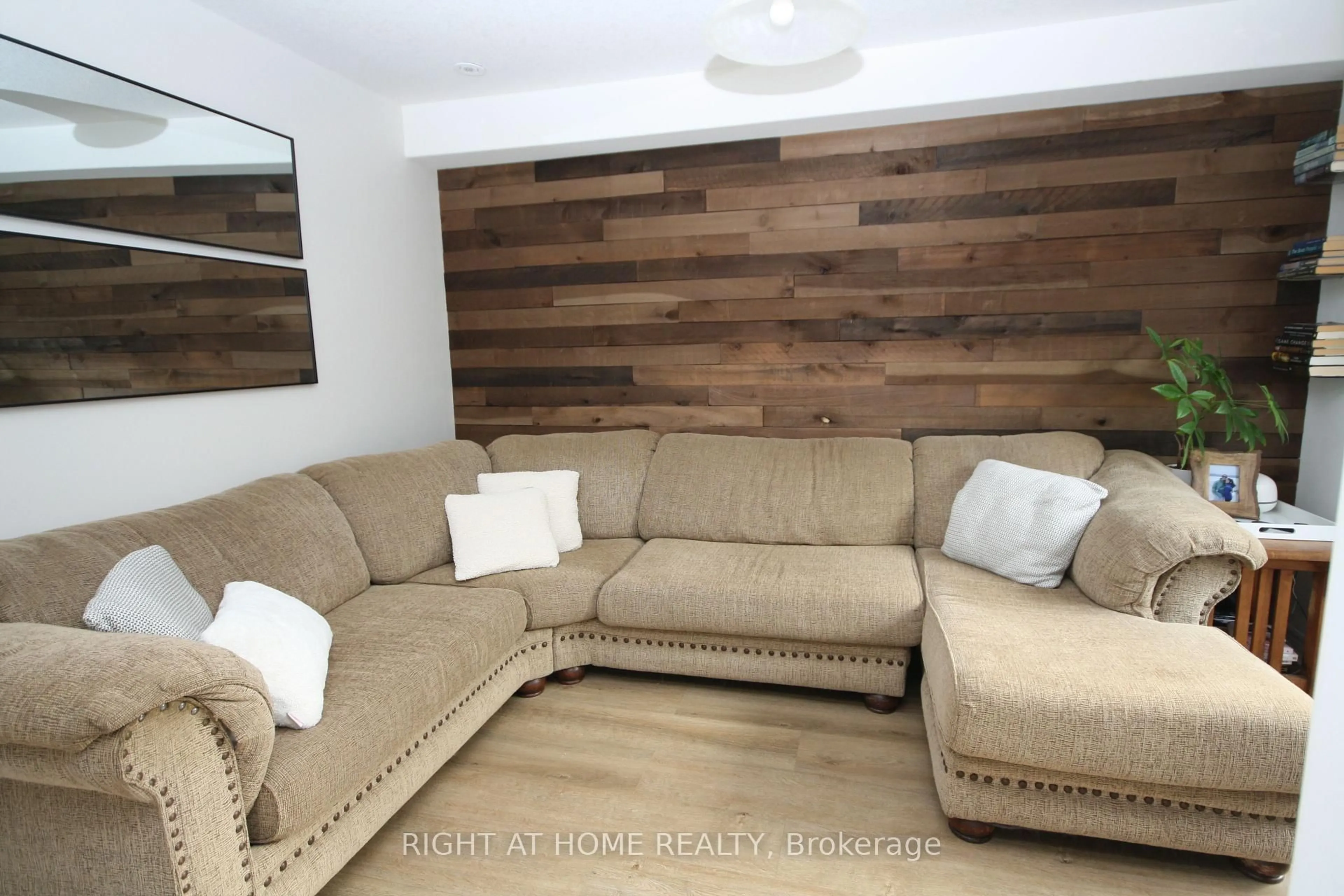 Living room with furniture, wood/laminate floor for 1039 Cook Dr, Midland Ontario L4R 0E4