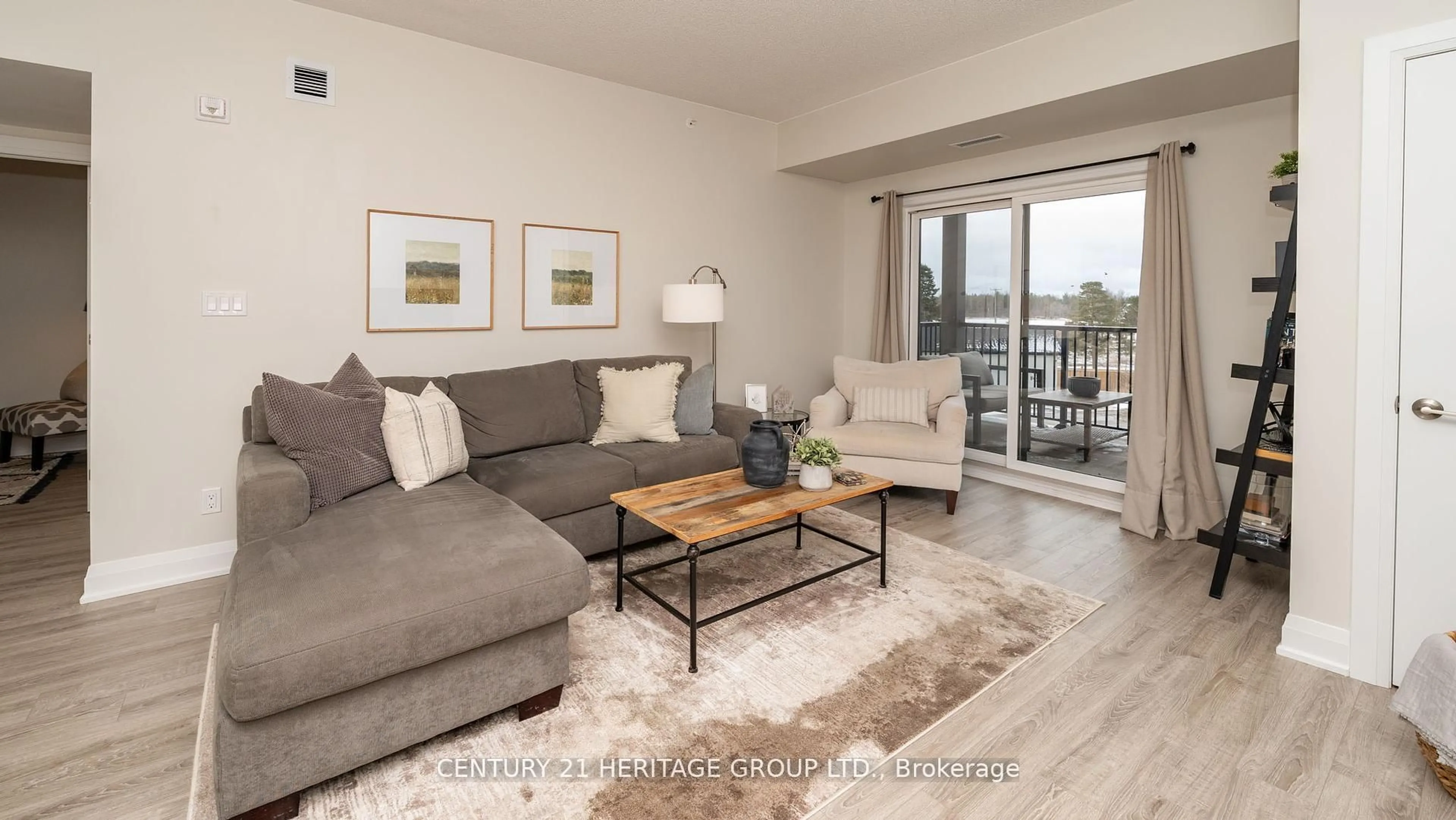 Living room with furniture, wood/laminate floor for 54 Koda St #207, Barrie Ontario L9J 0J6