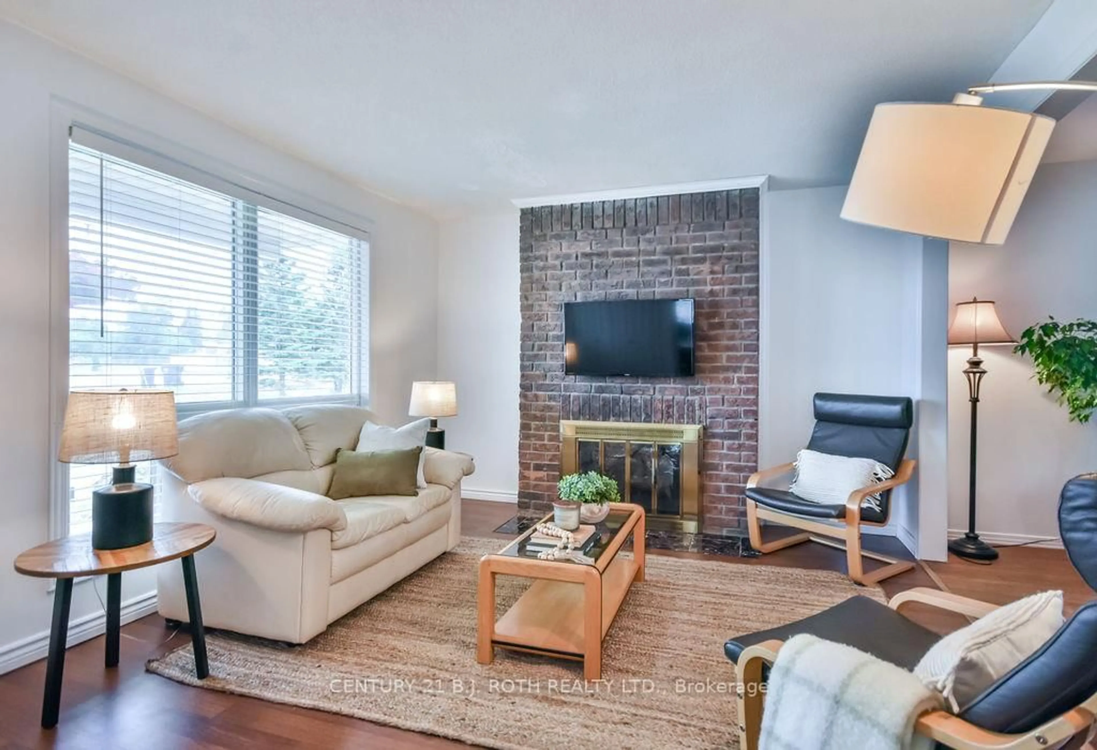 Living room with furniture, wood/laminate floor for 1143 Bayfield St, Springwater Ontario L9X 0N6