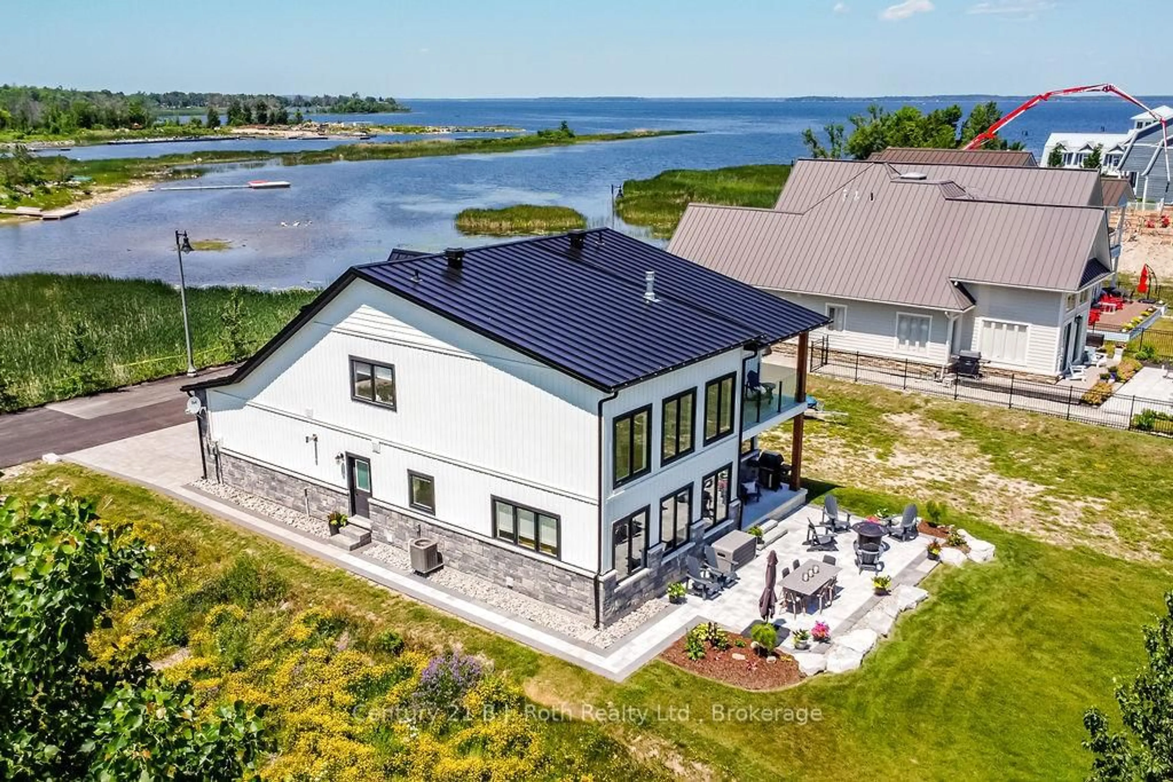 A pic from outside/outdoor area/front of a property/back of a property/a pic from drone, water/lake/river/ocean view for 53 Dock Lane #27, Tay Ontario L0K 1R0