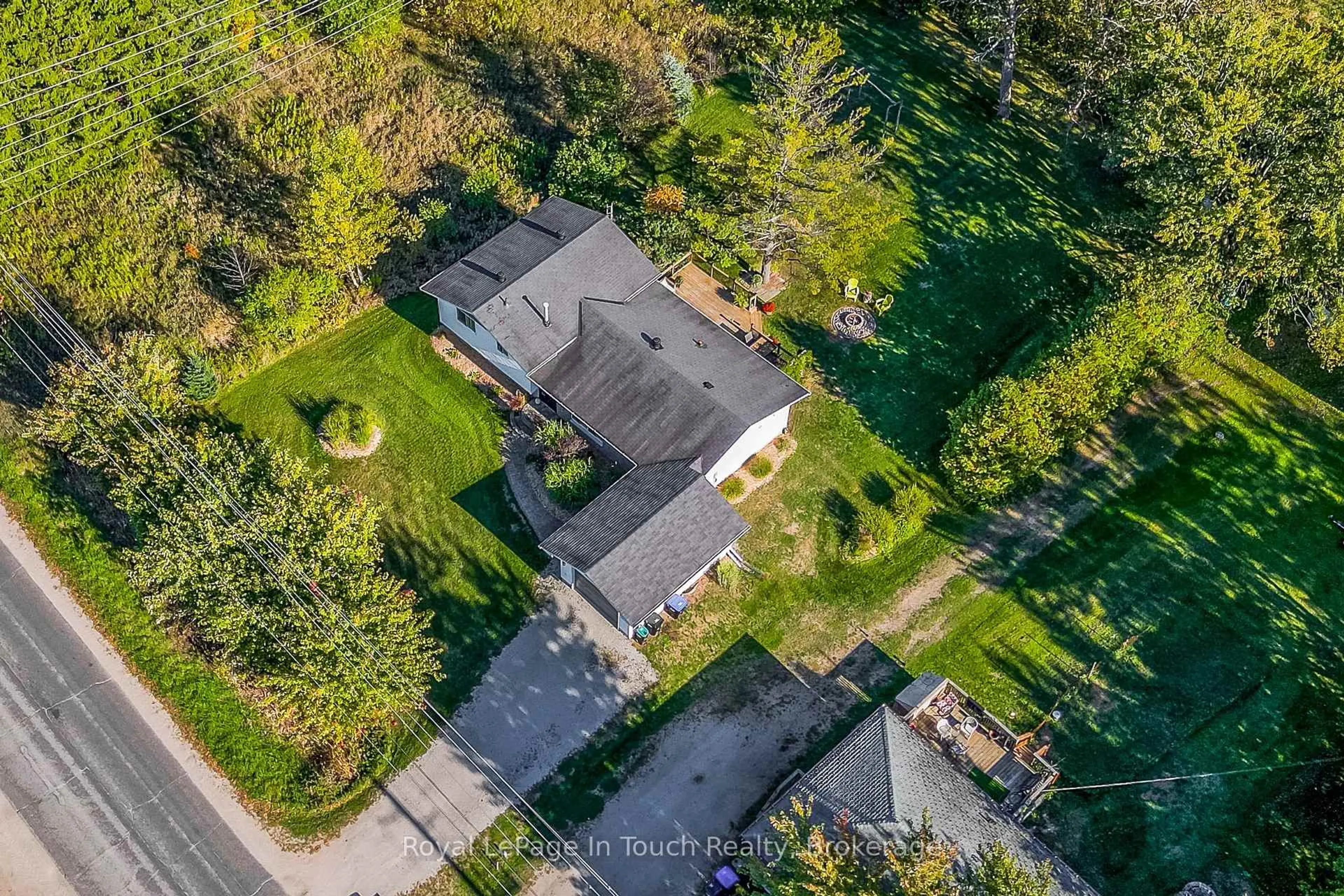 A pic from outside/outdoor area/front of a property/back of a property/a pic from drone, street for 1023 Flos 4 Rd, Springwater Ontario L0L 2K0