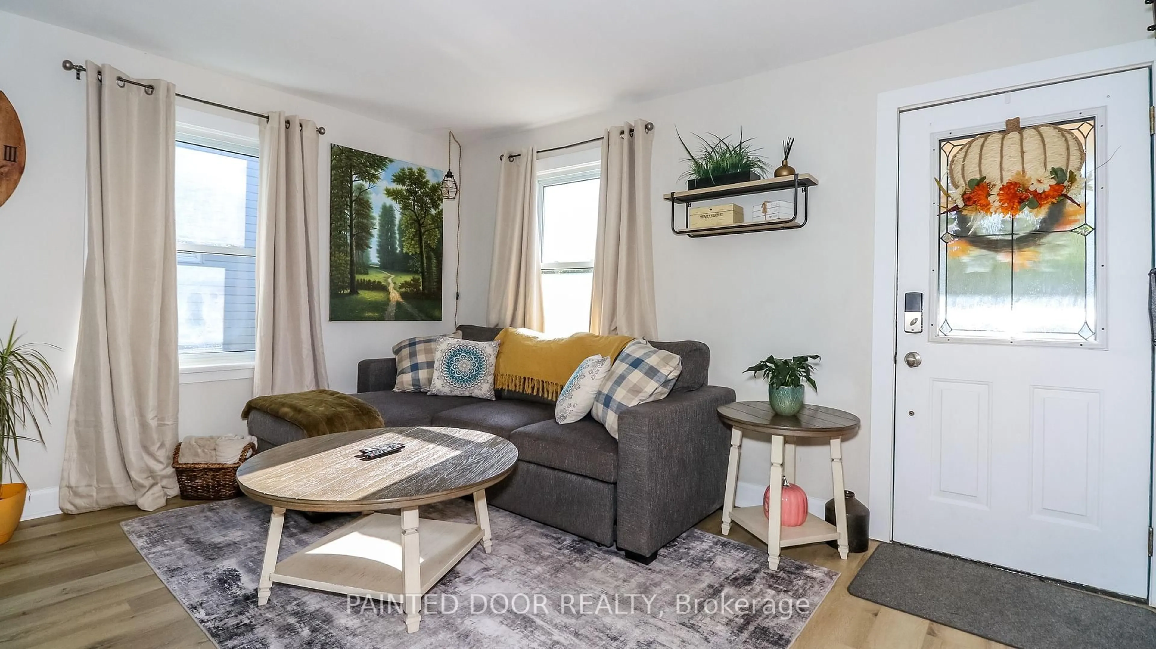 Living room with furniture, wood/laminate floor for 7 Albany Ave, Orillia Ontario L3V 2T2