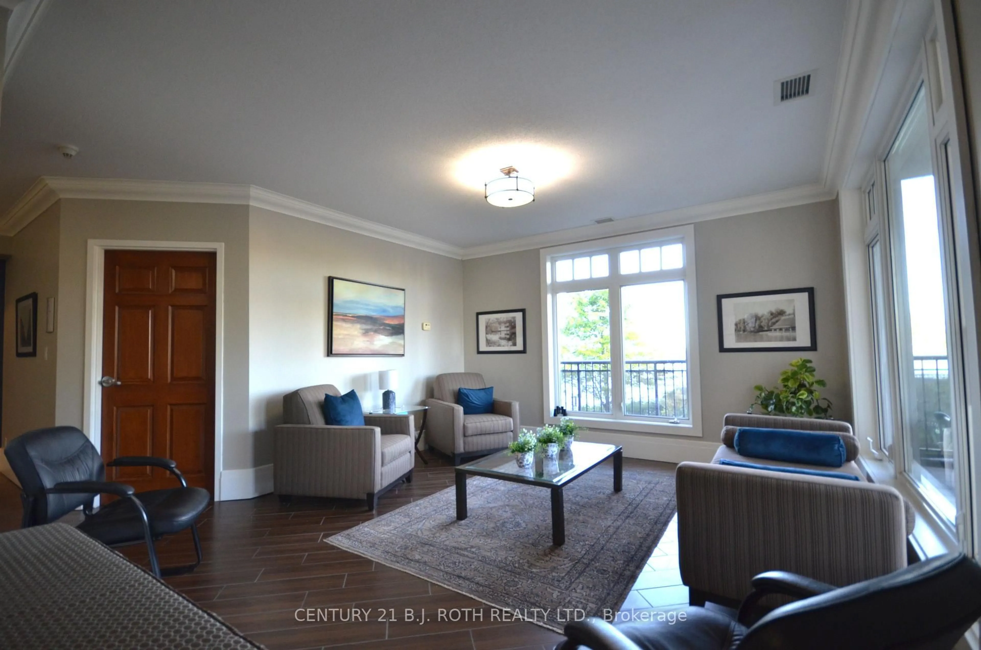 Living room with furniture, wood/laminate floor for 140 Cedar Island Rd #311, Orillia Ontario L3V 1T1