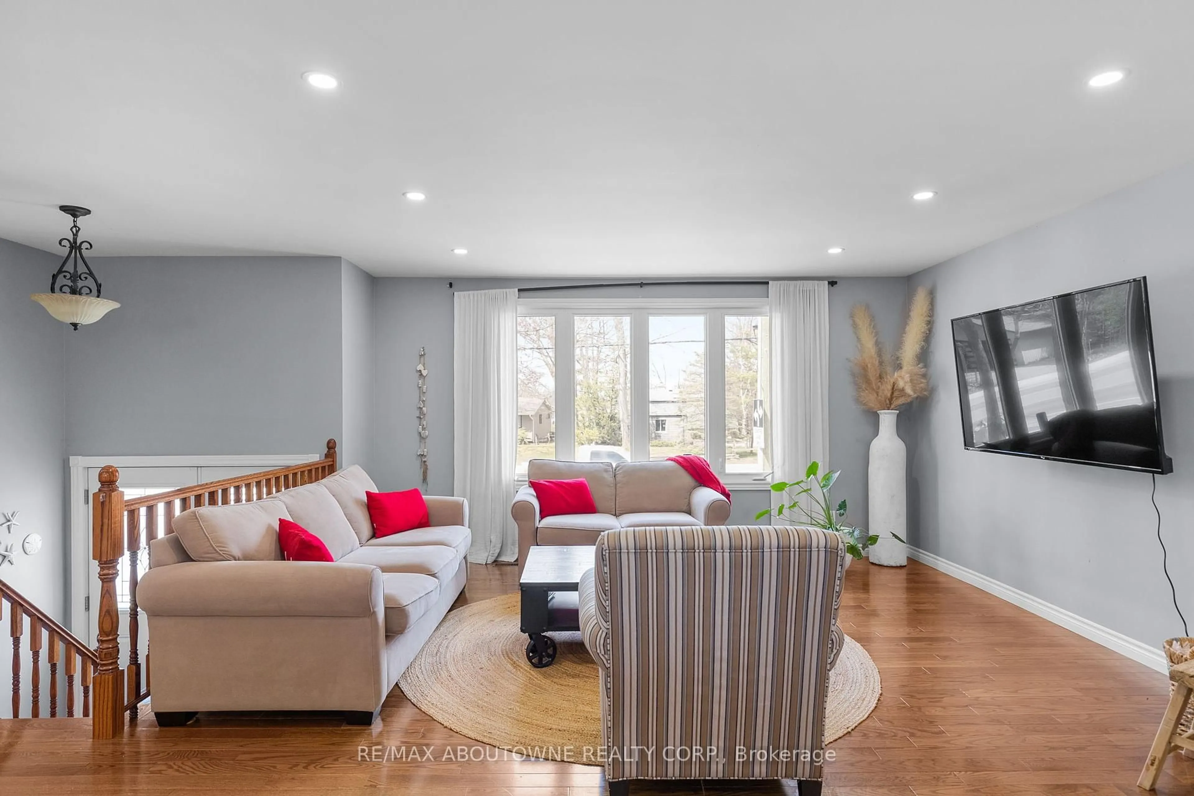 Living room with furniture, wood/laminate floor for 1877 River Rd, Wasaga Beach Ontario L9Z 1L1