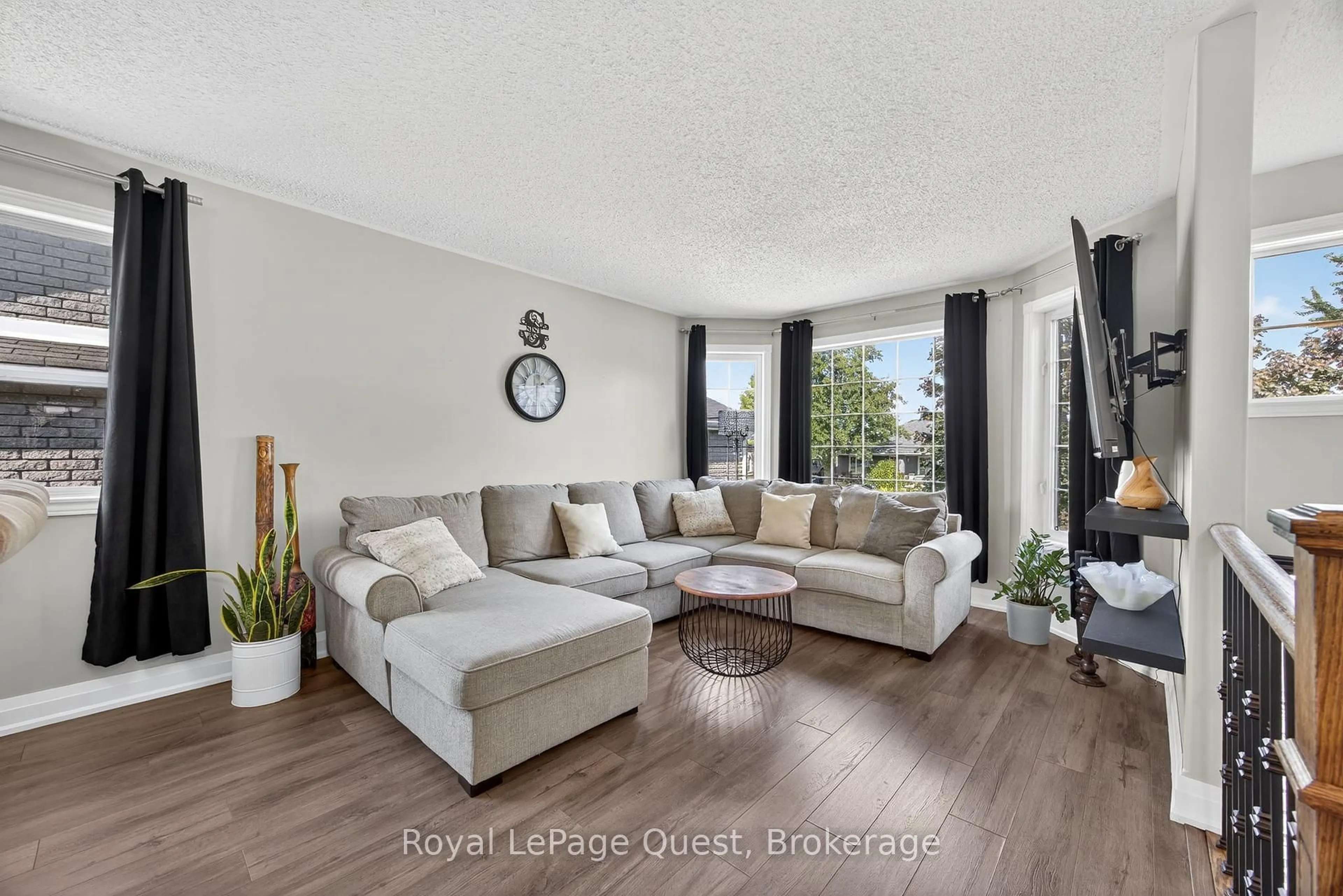 Living room with furniture, wood/laminate floor for 13 Graham St, Springwater Ontario L0L 1P0