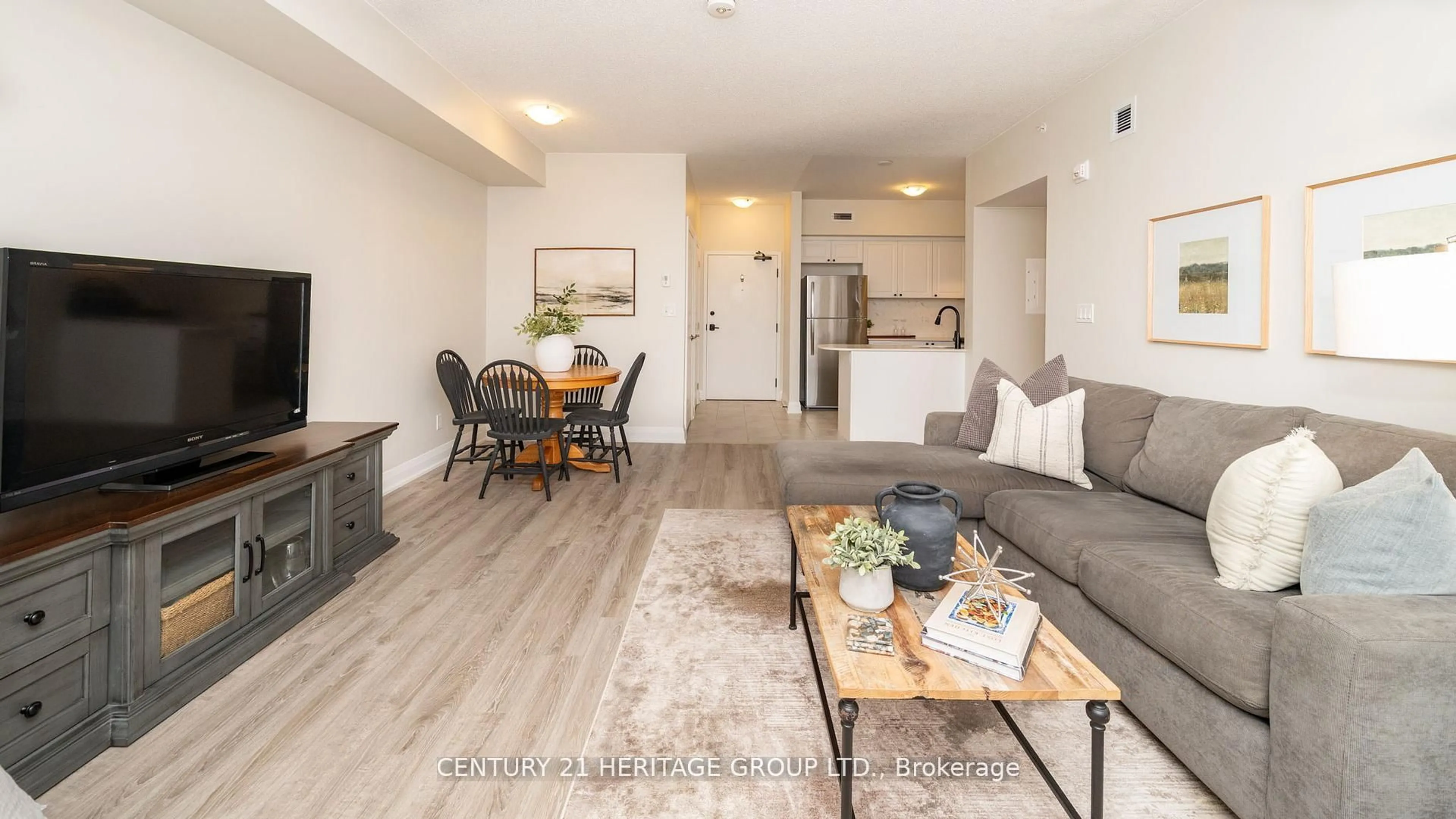 Living room with furniture, wood/laminate floor for 54 Koda St #207, Barrie Ontario L9J 0J6