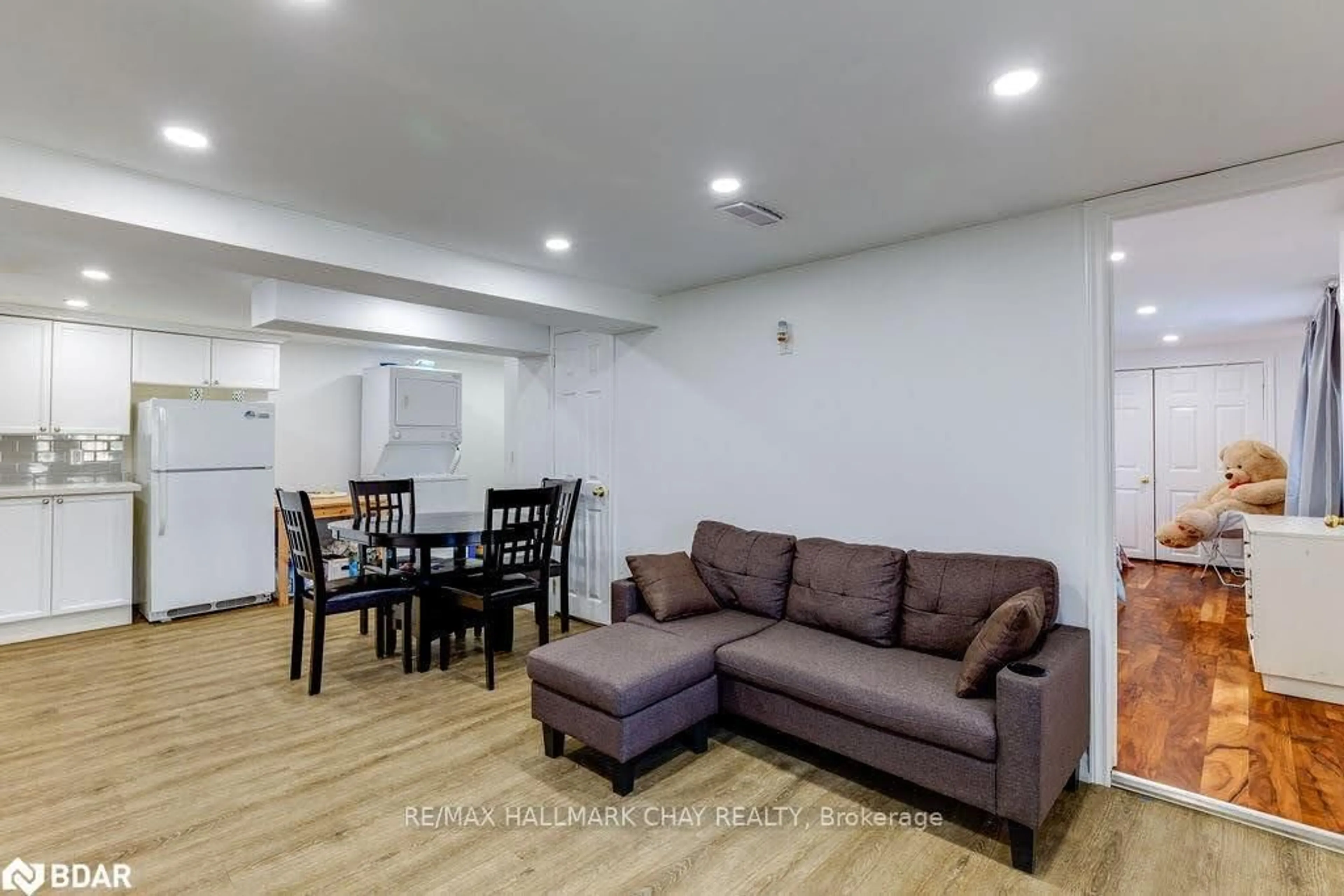 Living room with furniture, wood/laminate floor for 141 Ardagh Rd, Barrie Ontario L4N 3V5