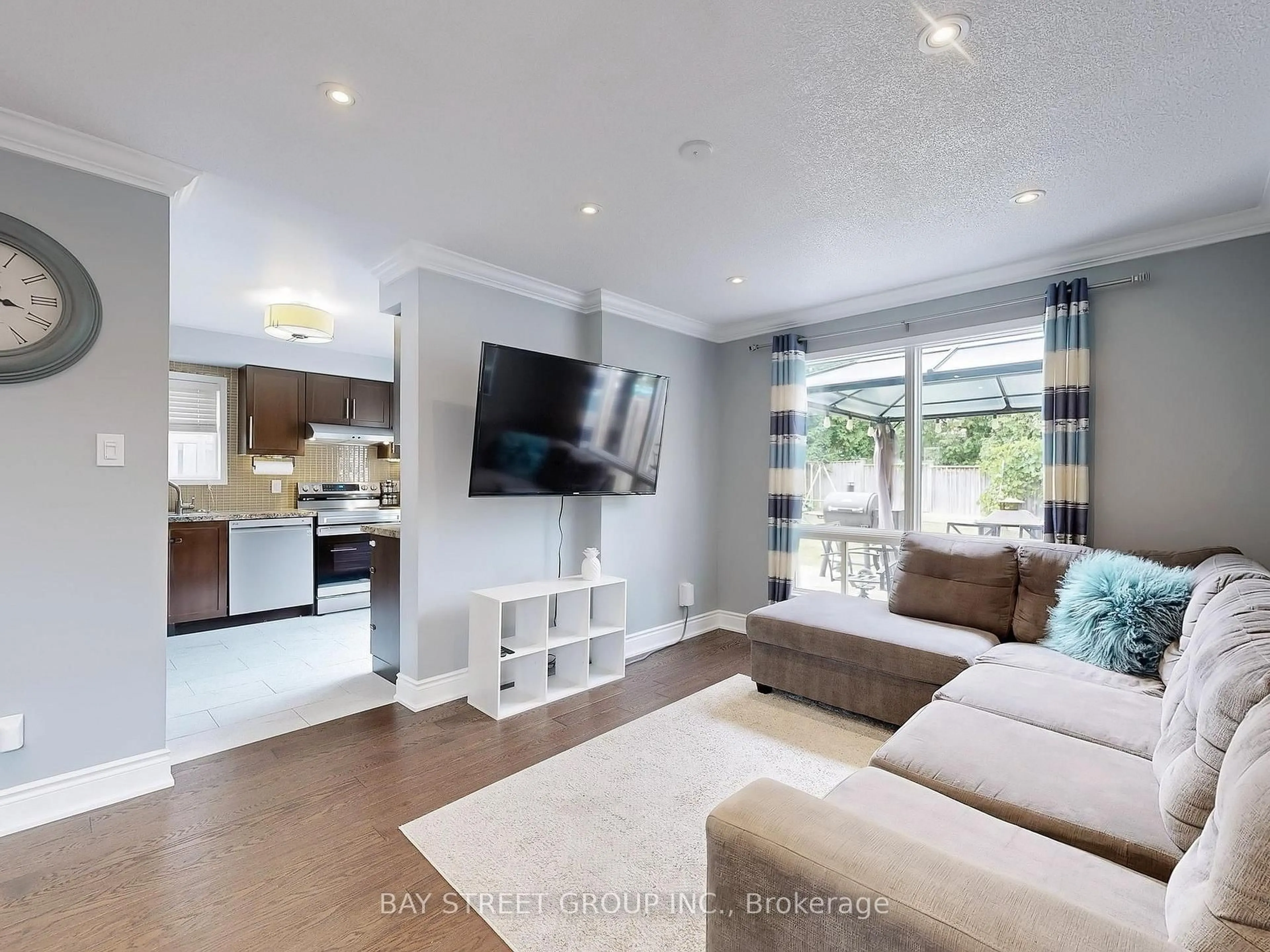 Living room with furniture, wood/laminate floor for 16 Bates Crt, Barrie Ontario L4N 8L8