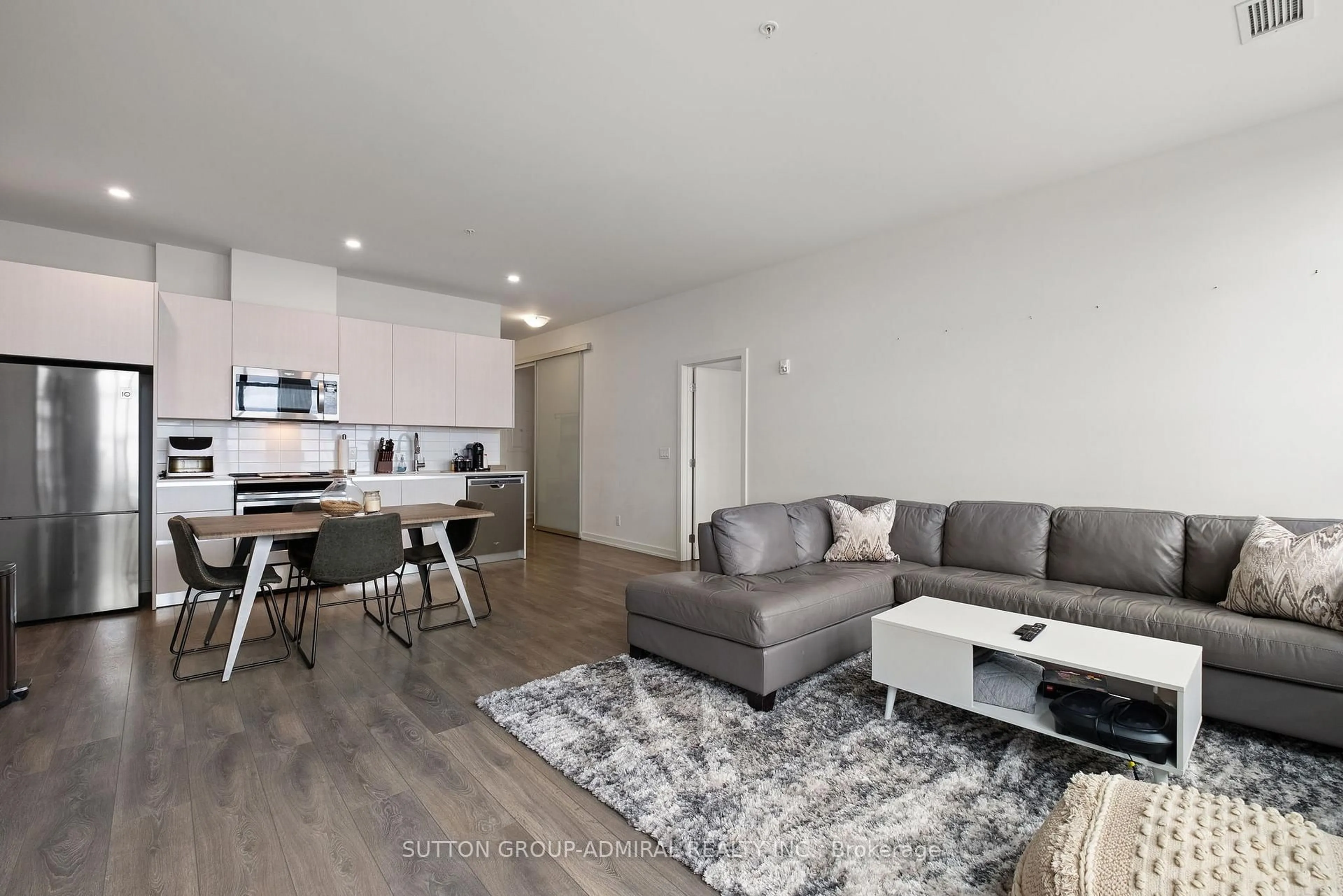 Living room with furniture, wood/laminate floor for 21 MATCHEDASH St #305, Orillia Ontario L3V 3T1