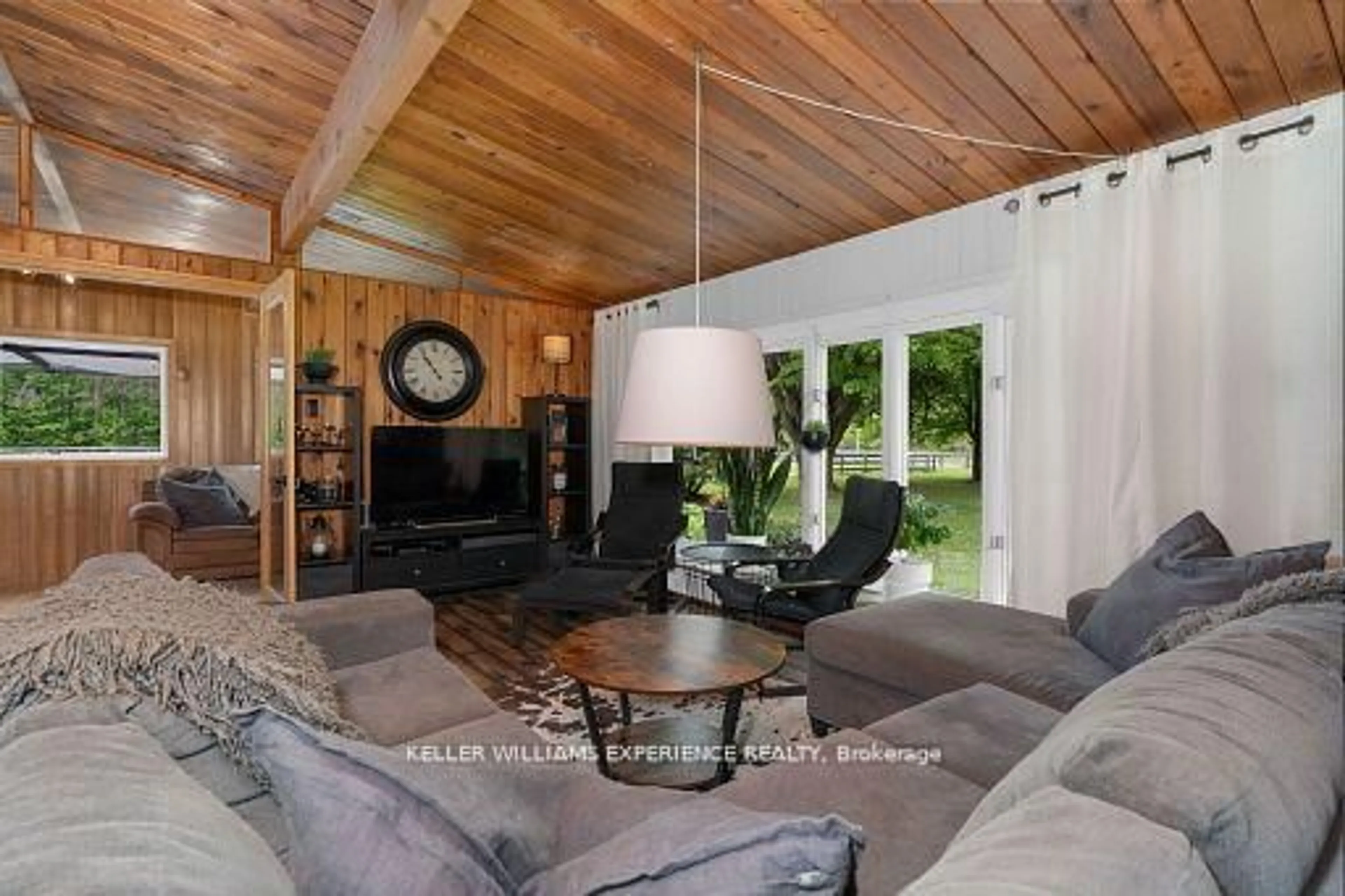 Living room with furniture, wood/laminate floor for 1398 Old Second Rd, Springwater Ontario L0L 2K0