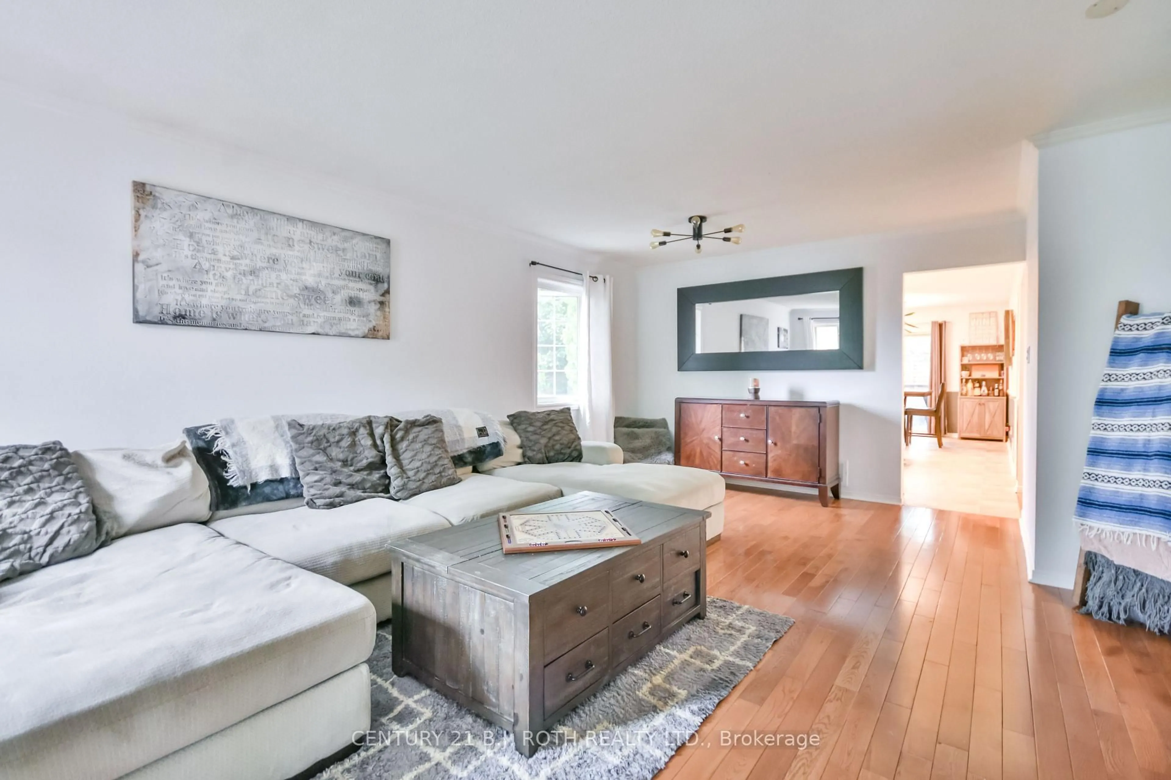 Living room with furniture, wood/laminate floor for 56 Monique Cres, Barrie Ontario L4M 6Y4