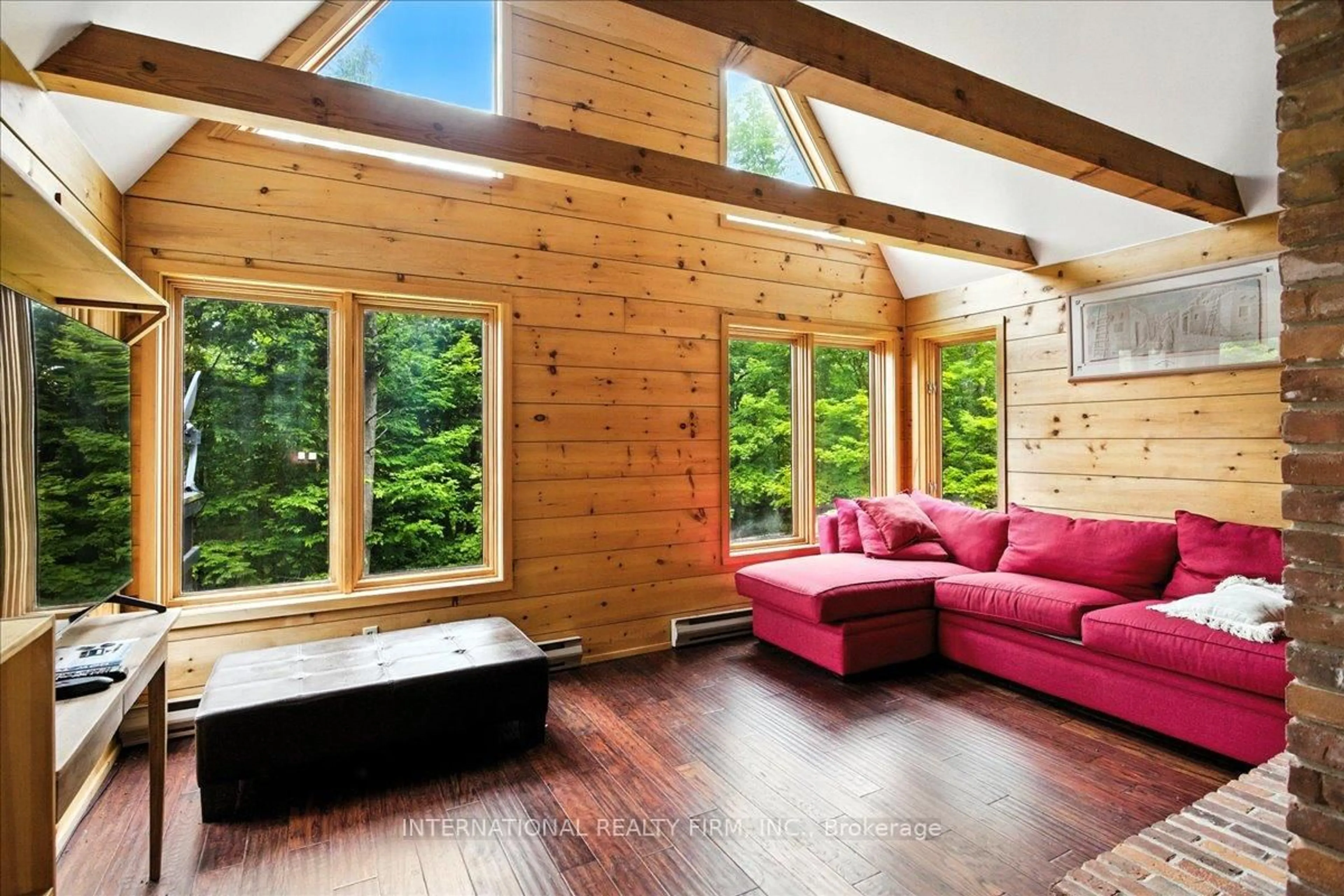 Living room with furniture, wood/laminate floor for 2445 Riverside Dr, Clearview Ontario L0M 1G0