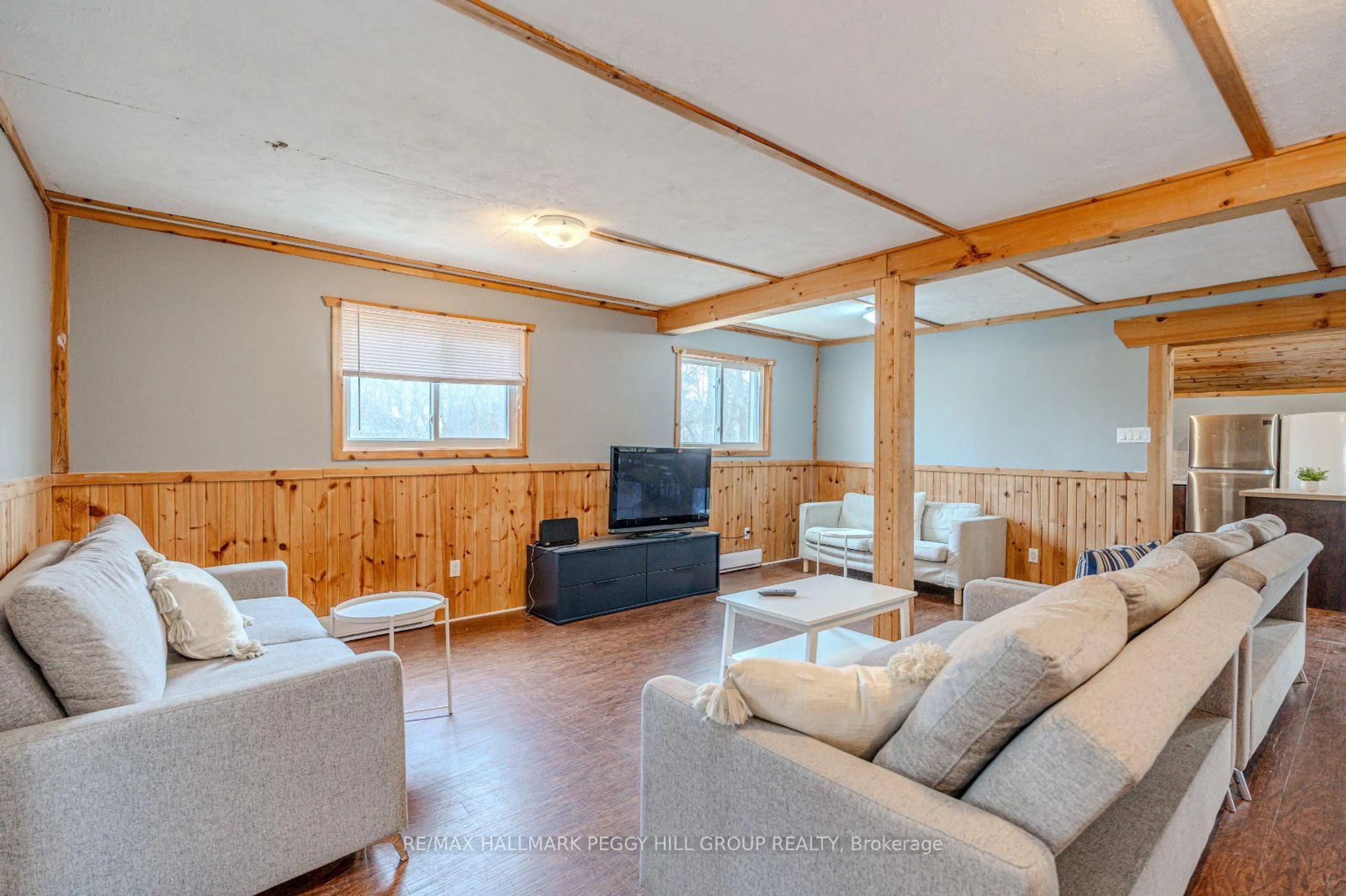 Living room with furniture, wood/laminate floor for 711 Mosley St, Wasaga Beach Ontario L9Z 1Z5