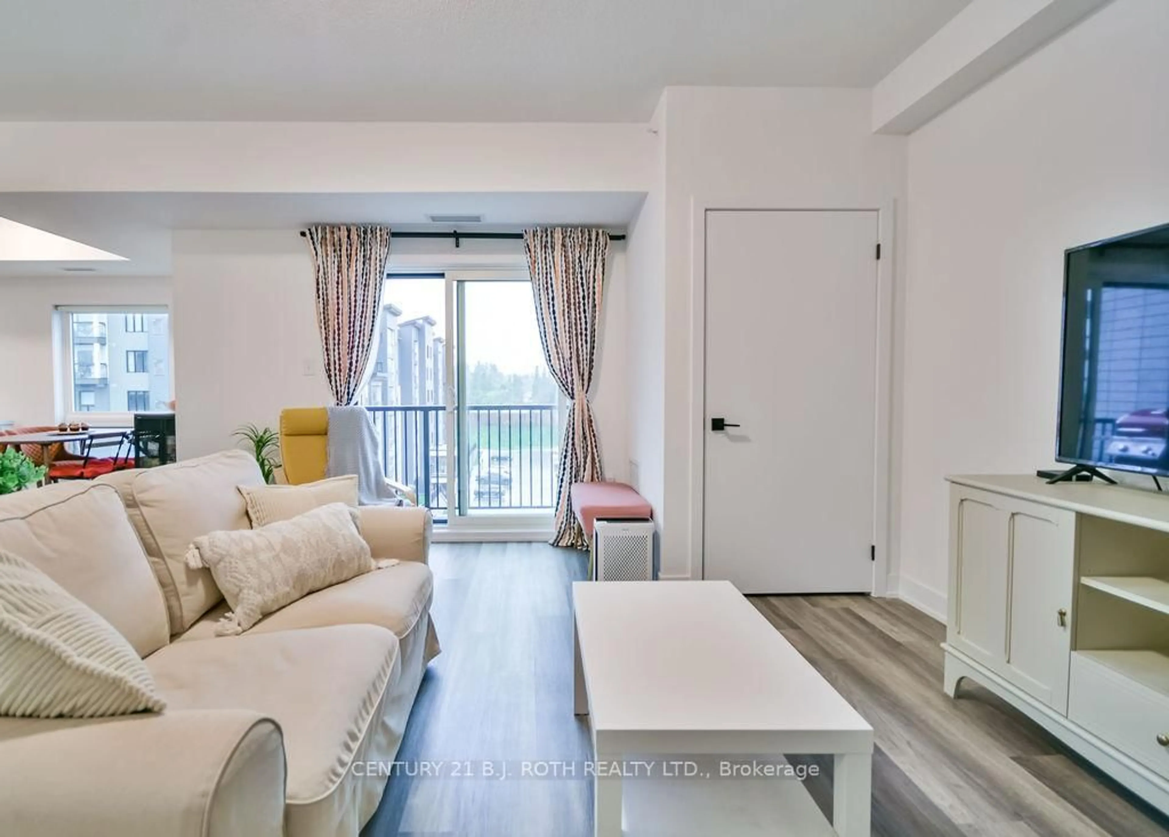 Living room with furniture, wood/laminate floor for 8 Culinary Lane #502, Barrie Ontario L9J 0T2