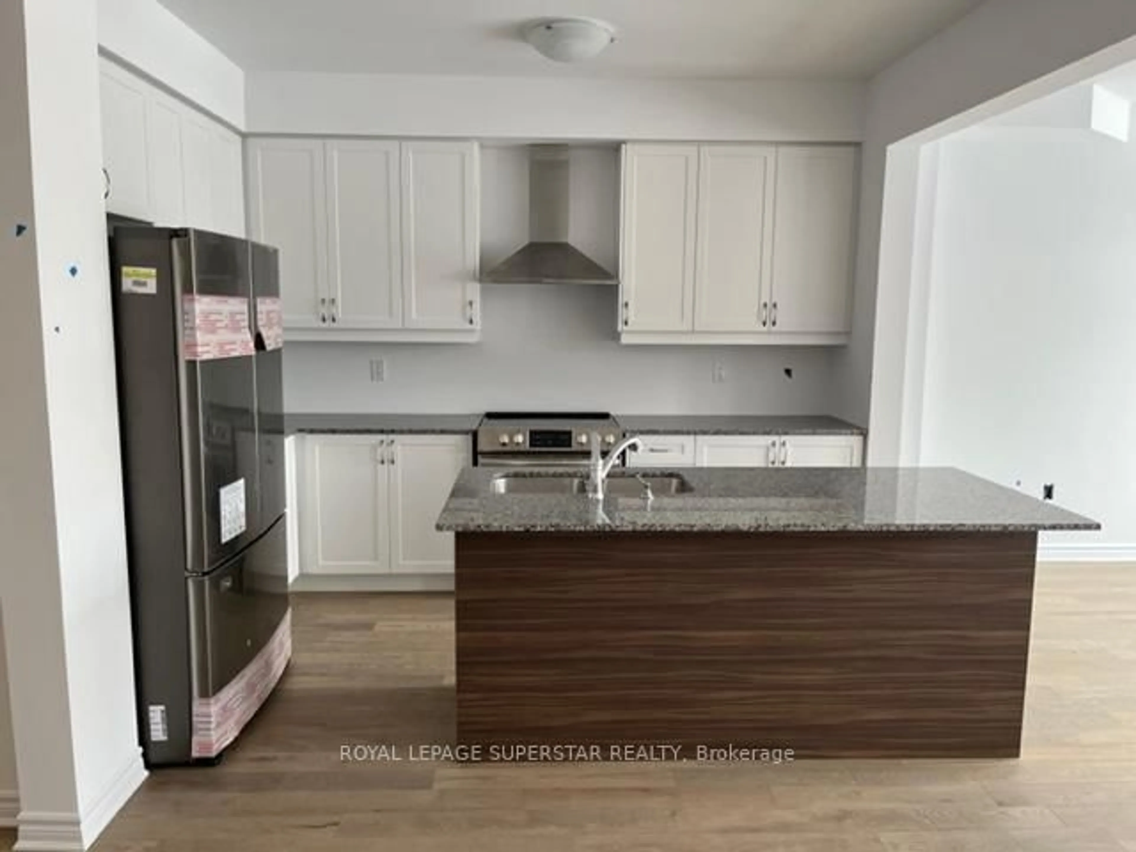Open concept kitchen, wood/laminate floor for 42 Eberhardt Dr, Wasaga Beach Ontario L9E 0K6
