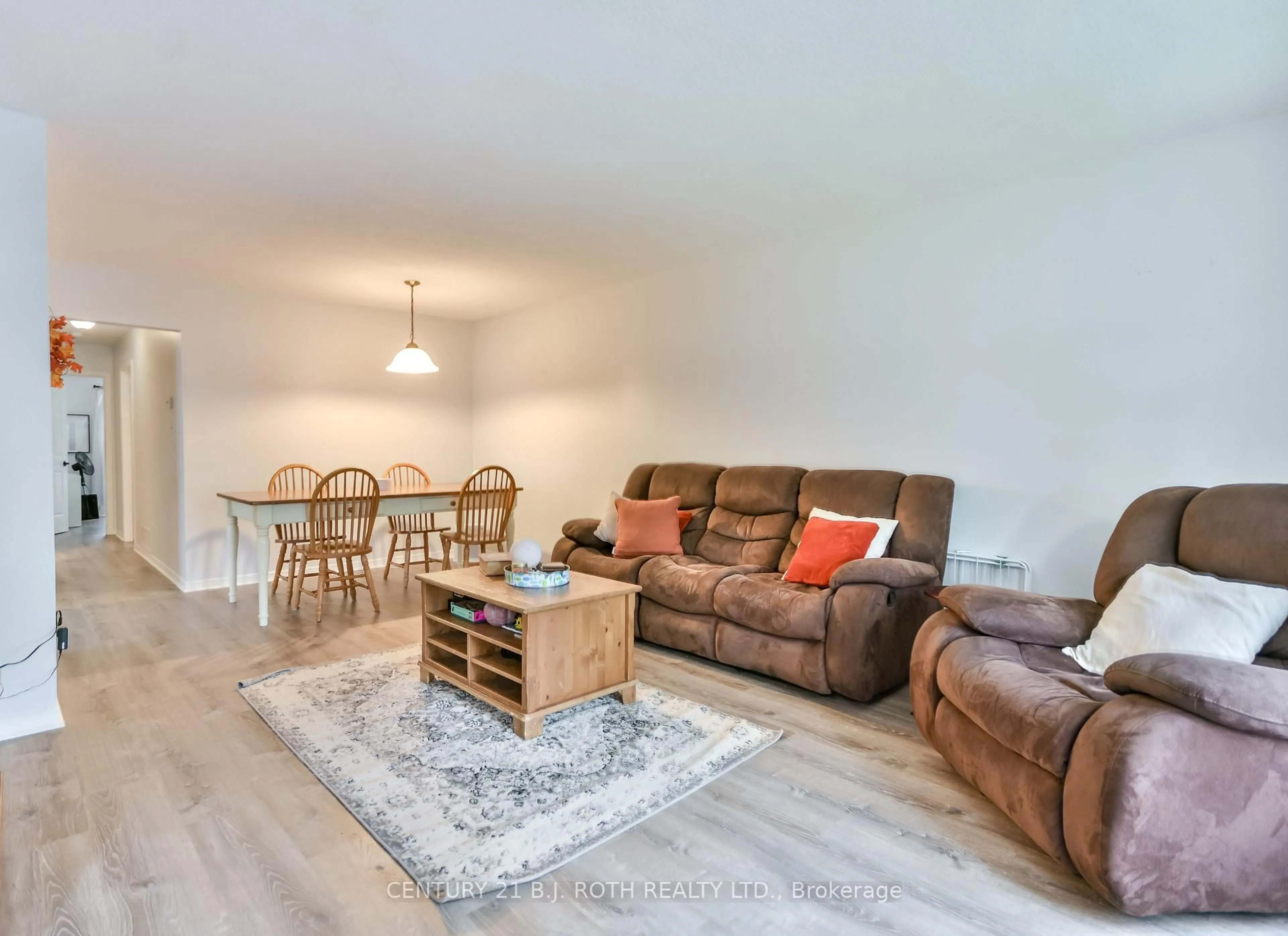 Living room with furniture, wood/laminate floor for 75 Bernick Dr, Barrie Ontario L4M 5C1
