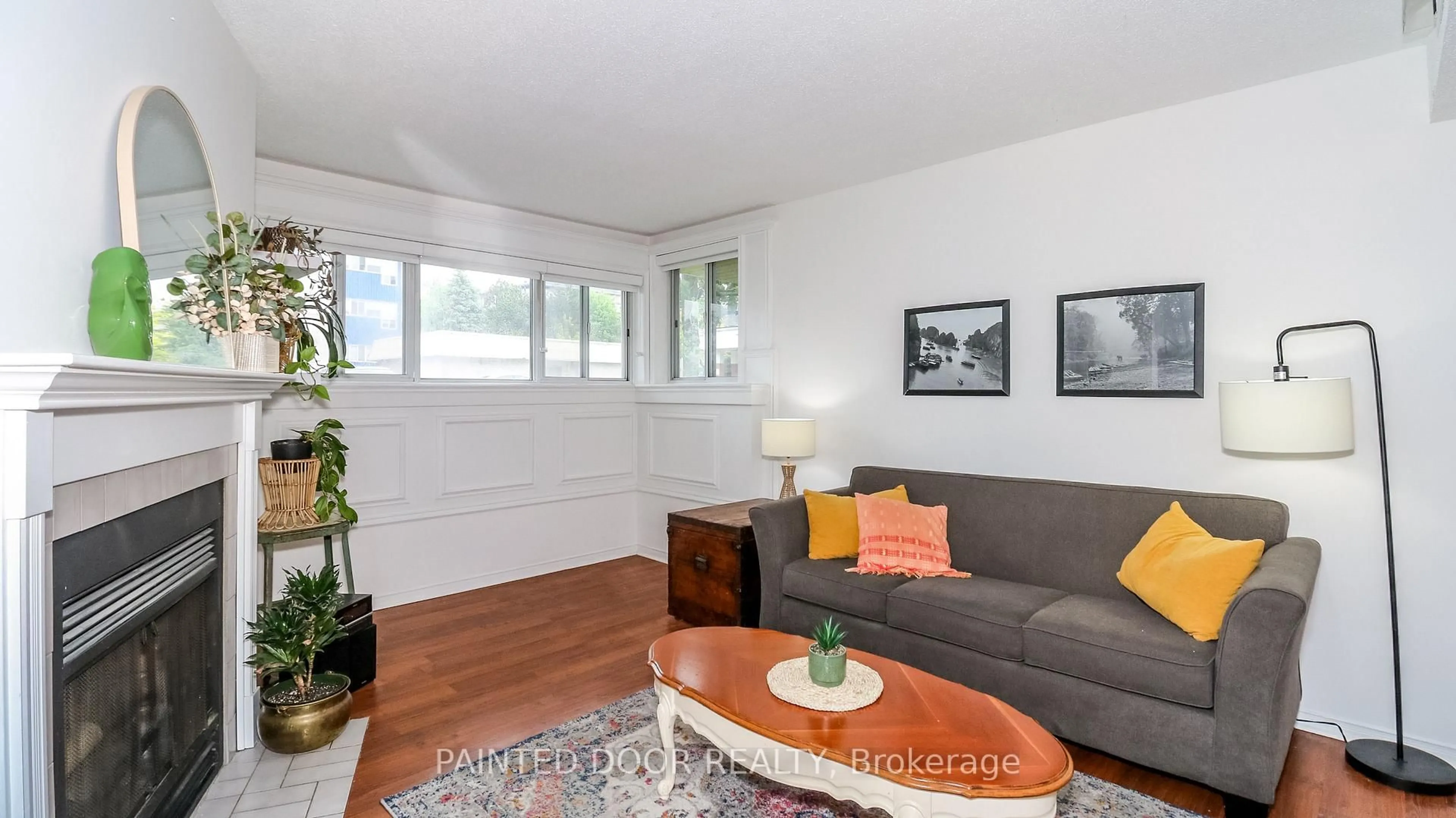 Living room with furniture, wood/laminate floor for 126 Bell Farm Rd #113, Barrie Ontario L4M 6J3