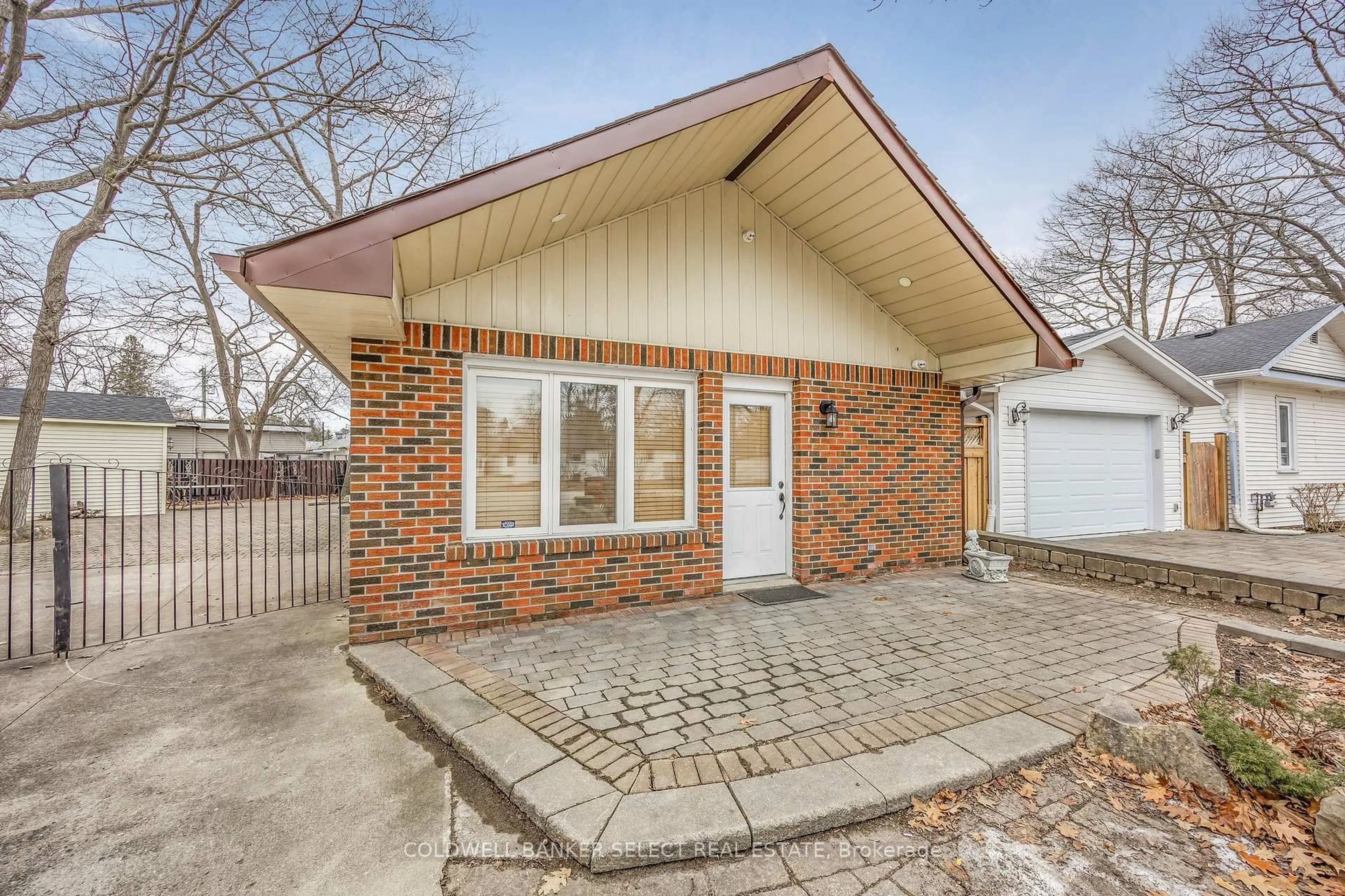 Home with brick exterior material, street for 77 & 79 Baker St, Wasaga Beach Ontario L9Z 2G7
