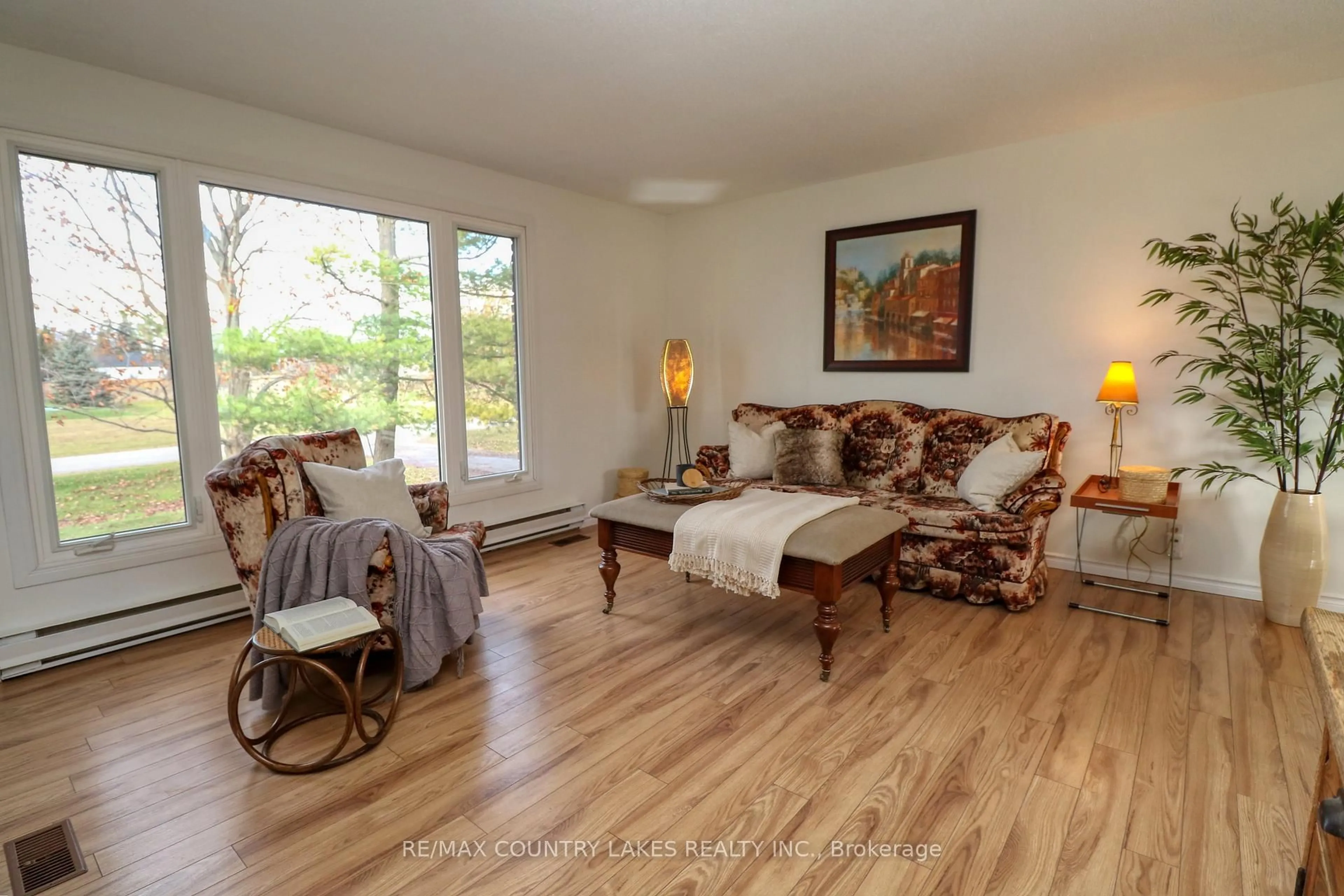 Living room with furniture, wood/laminate floor for 2899 Georgina Dr, Ramara Ontario L0K 1B0