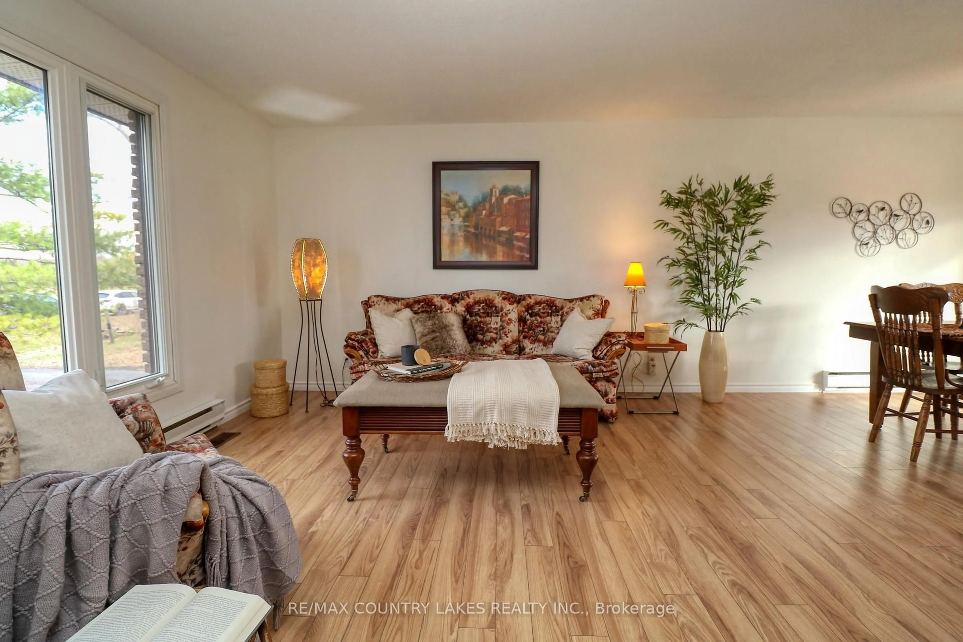 Living room with furniture, wood/laminate floor for 2899 Georgina Dr, Ramara Ontario L0K 1B0