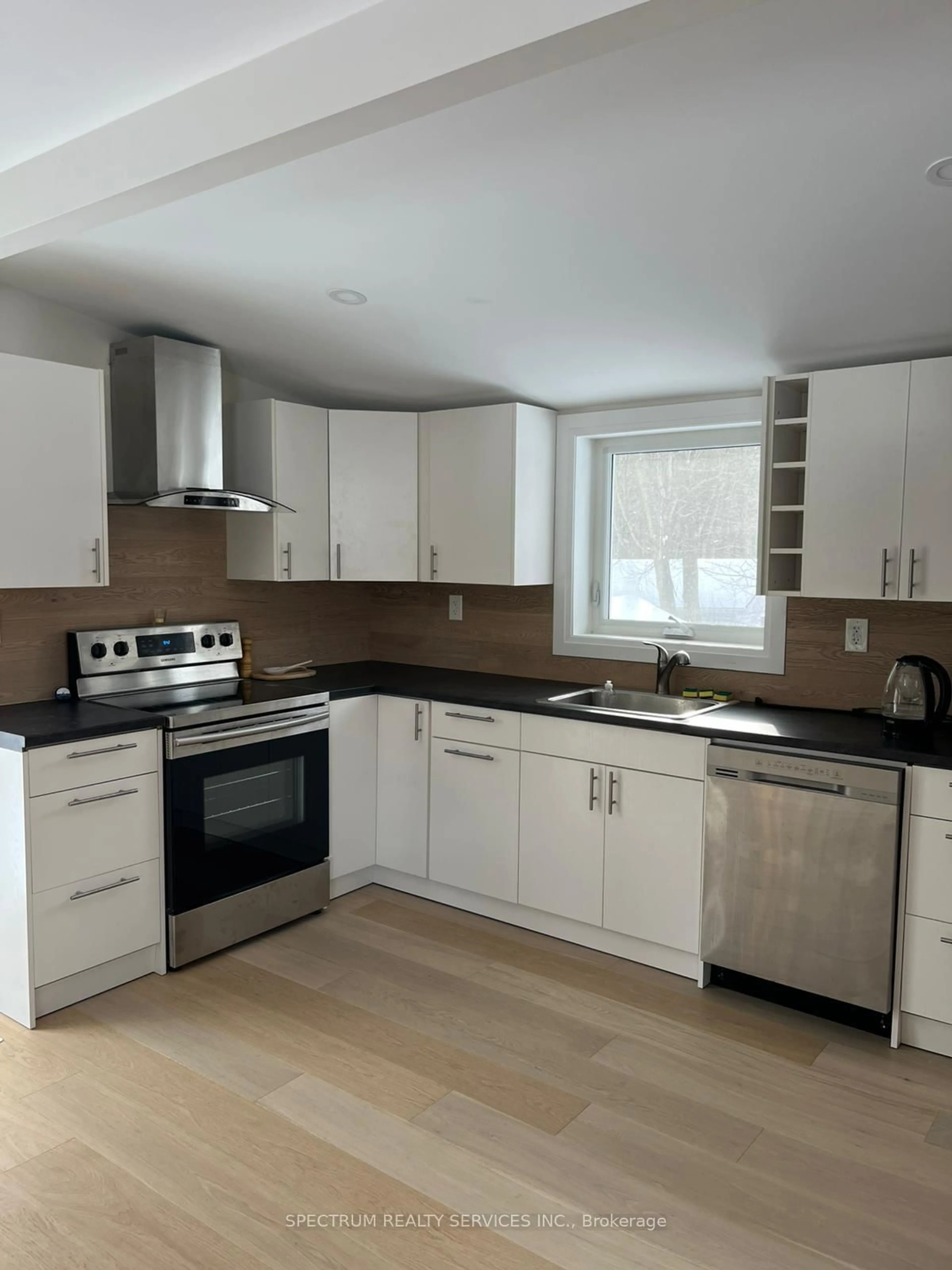 Open concept kitchen, wood/laminate floor for 161 Antigua Dr, Wasaga Beach Ontario L9Z 2S2