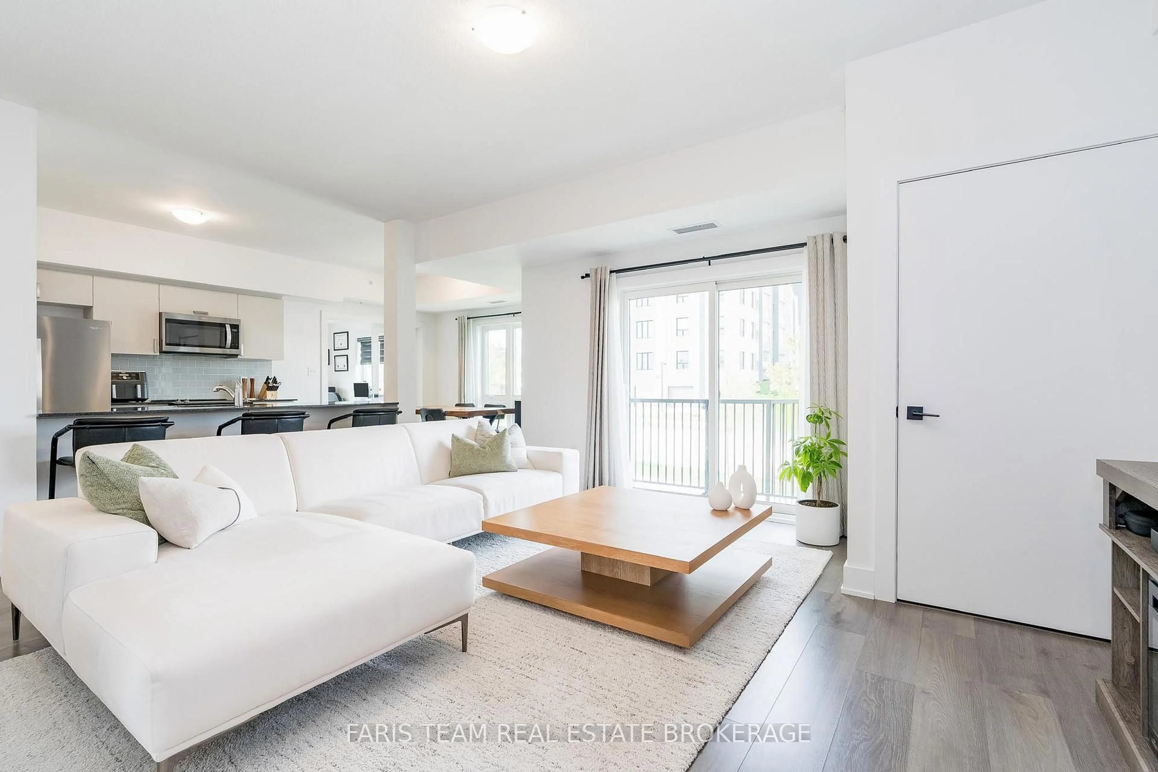 Living room with furniture, wood/laminate floor for 8 Culinary Lane #102, Barrie Ontario L9J 0T2