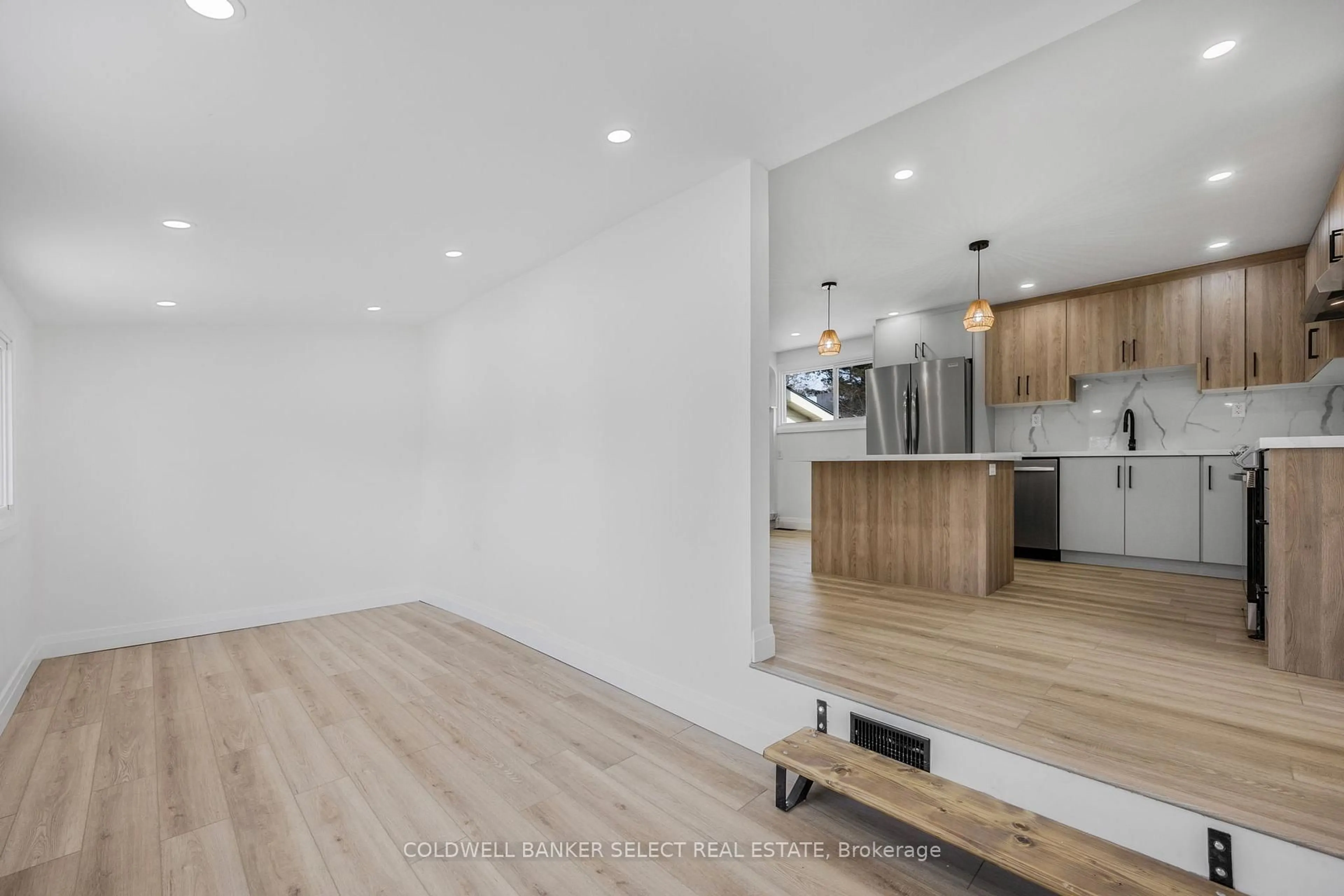 Open concept kitchen, wood/laminate floor for 338 Old Mosley St, Wasaga Beach Ontario L9Z 2H6