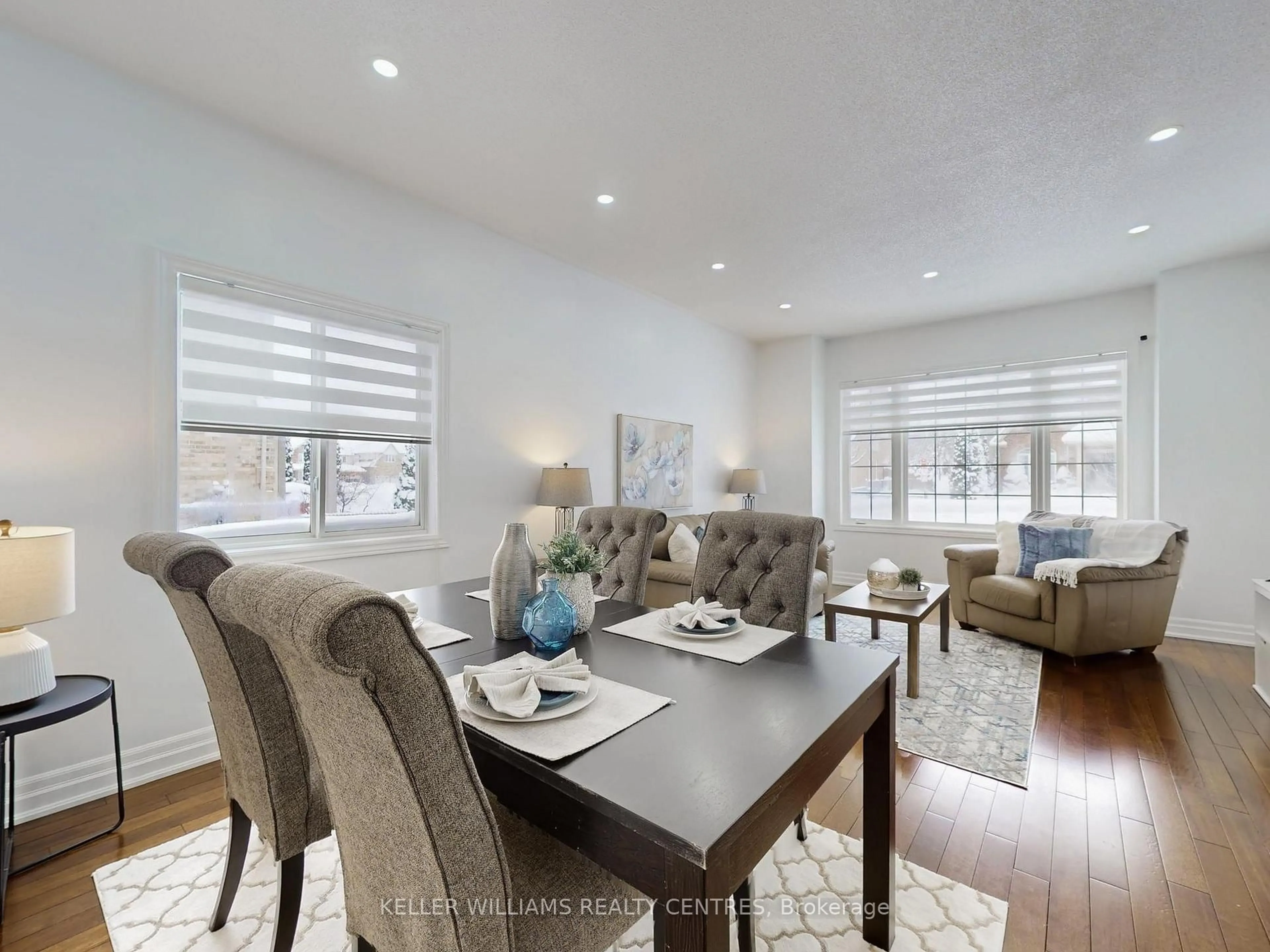 Living room with furniture, wood/laminate floor for 19 Thrushwood Dr, Barrie Ontario L4N 0Z1