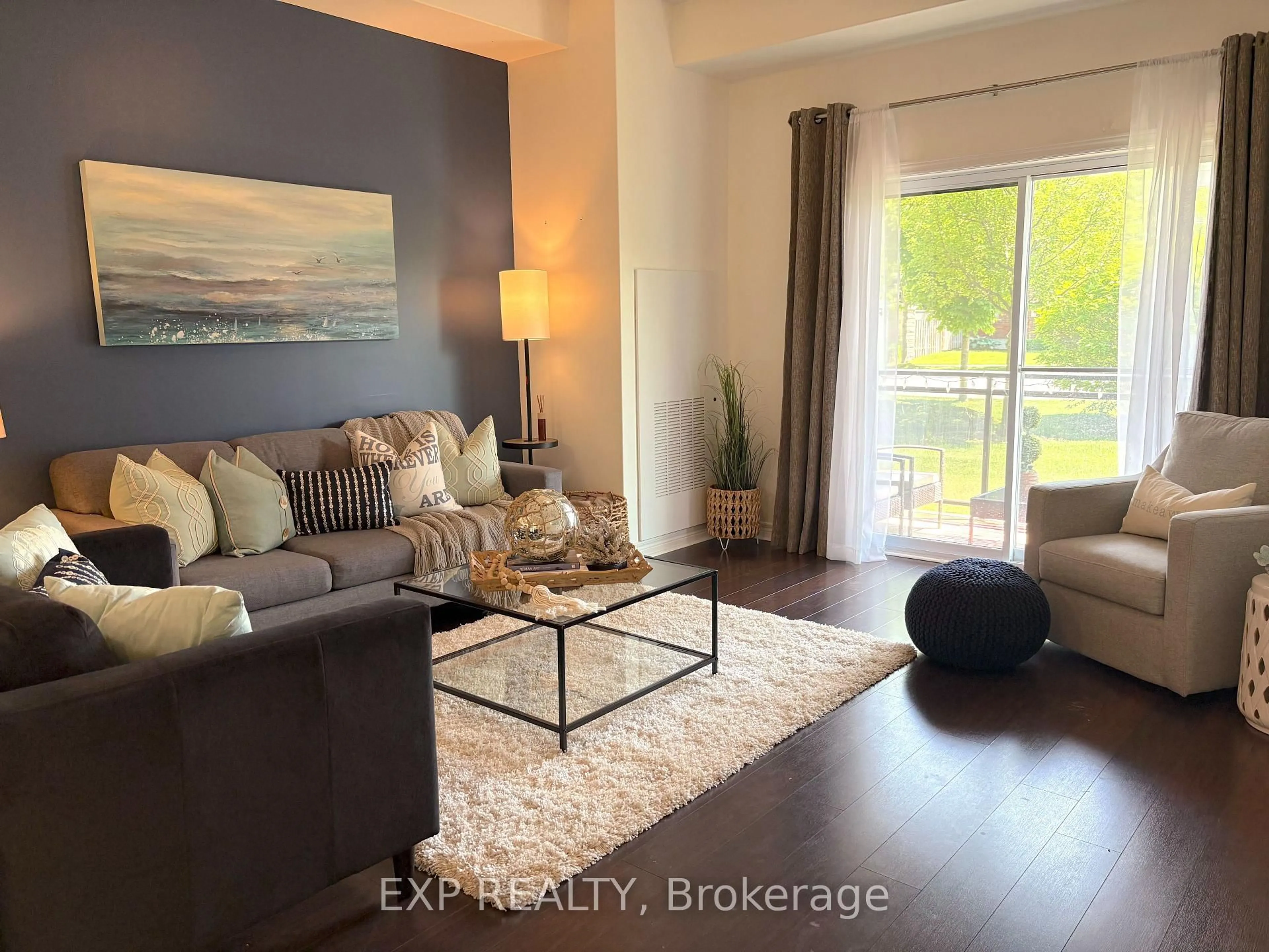 Living room with furniture, wood/laminate floor for 1 Chamberlain Cres #102, Collingwood Ontario L9Y 0E3