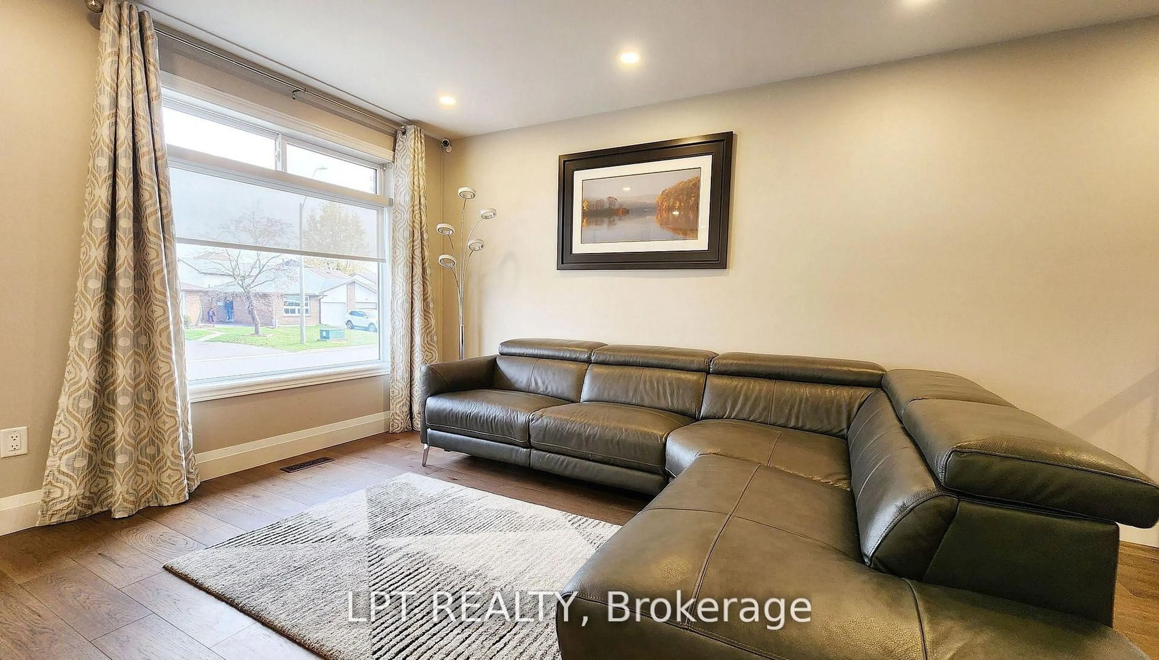 Living room with furniture, wood/laminate floor for 48 Maplehurst Cres, Barrie Ontario L4M 4X2