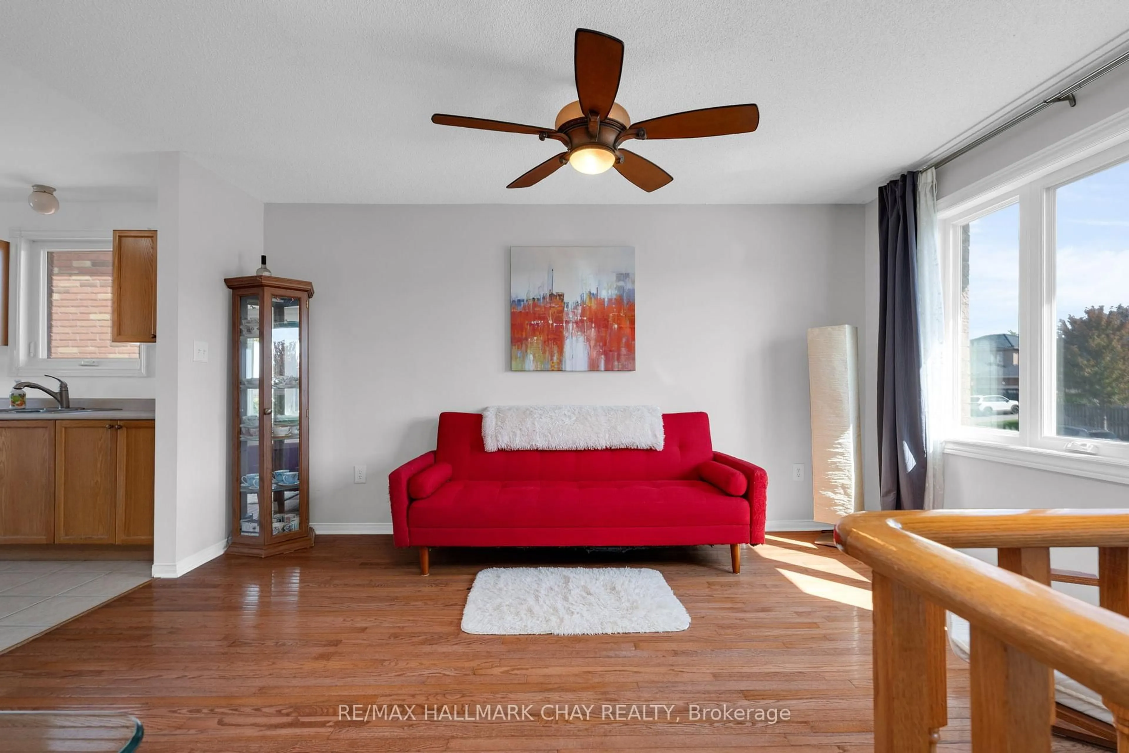 Living room with furniture, wood/laminate floor for 166 Country Lane, Barrie Ontario L4N 0T9