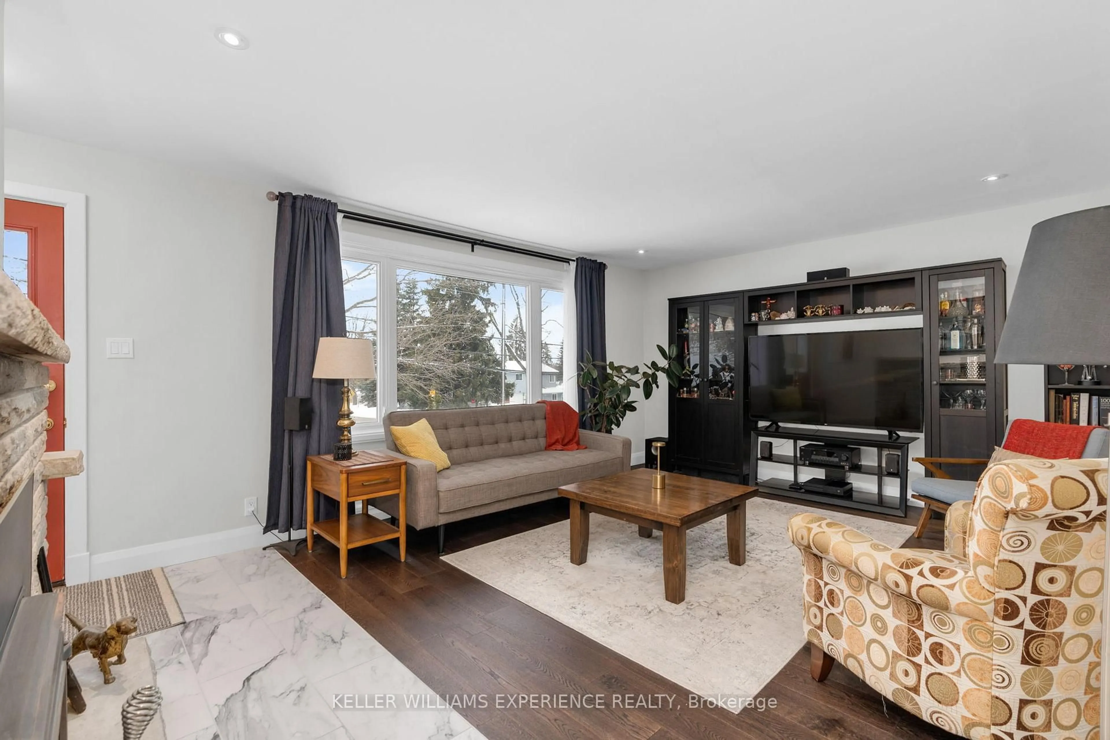 Living room with furniture, wood/laminate floor for 51 Fittons Rd, Orillia Ontario L3V 2J2