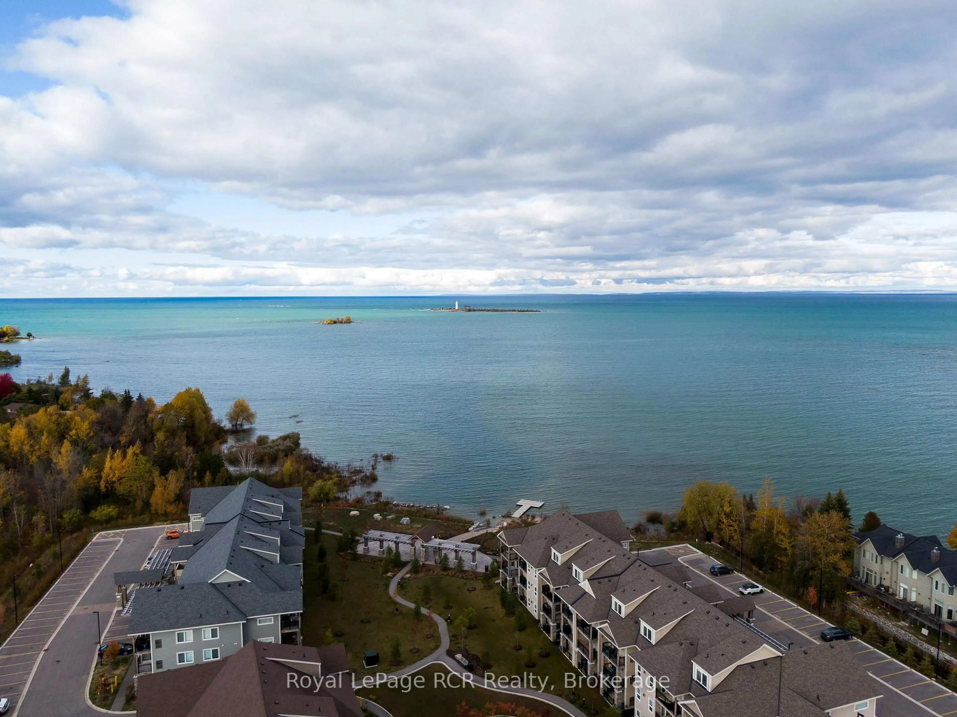 A pic from outside/outdoor area/front of a property/back of a property/a pic from drone, water/lake/river/ocean view for 2 COVE Crt #205, Collingwood Ontario L9Y 0Y6