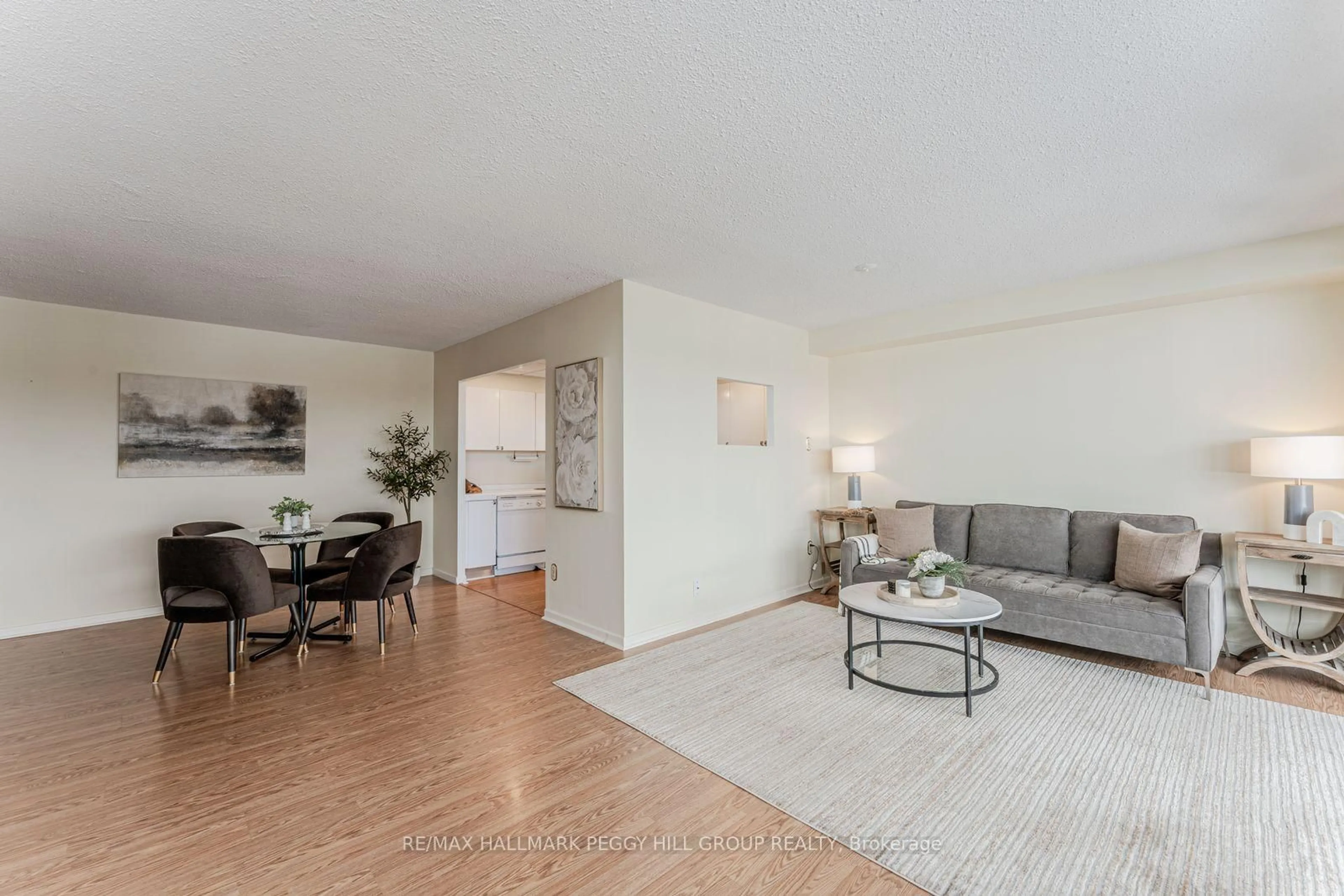 Living room with furniture, wood/laminate floor for 181 Collier St #803, Barrie Ontario L4M 5L6